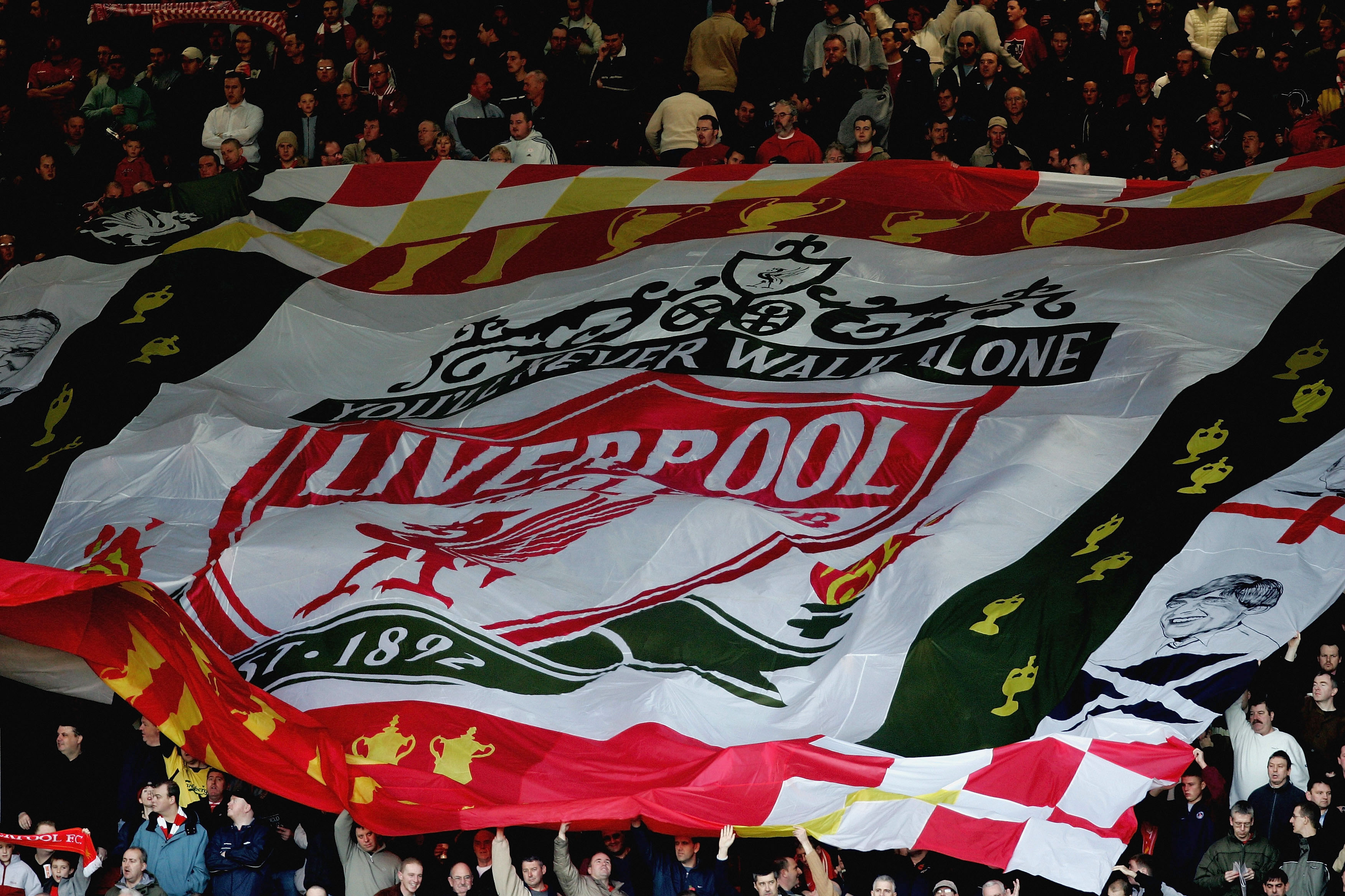 LIVERPOOL, ENGLAND - NOVEMBER 13:  A giant Liverpool flag above the crowd in the Kop Eng of Anfield before the Barclays Premiership match between Liverpool and Crystal Palace at Anfield, on November 13, 2004 in Liverpool, England.  (Photo by Ross Kinnaird