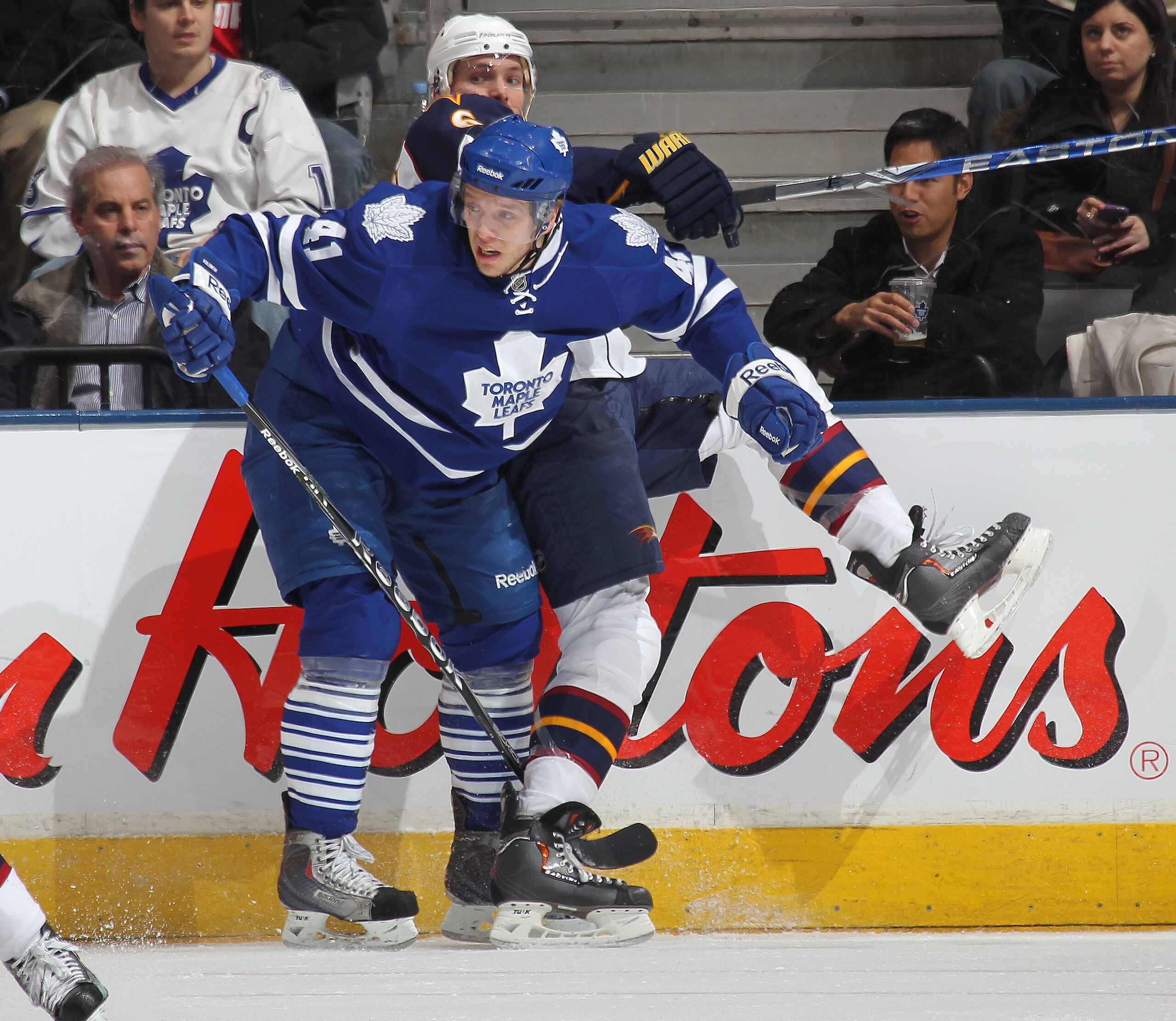 TORONTO, CANADA - FEBRUARY 7: Ron Hainsey #6 of the Atlanta Thrashers is taken into the boards by Nikolai Kulemin #41 of the Toronto Maple Leafs in a game on February 7, 2011 at the Air Canada Centre in Toronto, Canada. (Photo by Claus Andersen/Getty Ima TORONTO, CANADA - FEBRUARY 7: Ron Hainsey #6 of the Atlanta Thrashers is taken into the boards by Nikolai Kulemin #41 of the Toronto Maple Leafs in a game on February 7, 2011 at the Air Canada Centre in Toronto, Canada. (Photo by Claus Andersen/Getty Ima