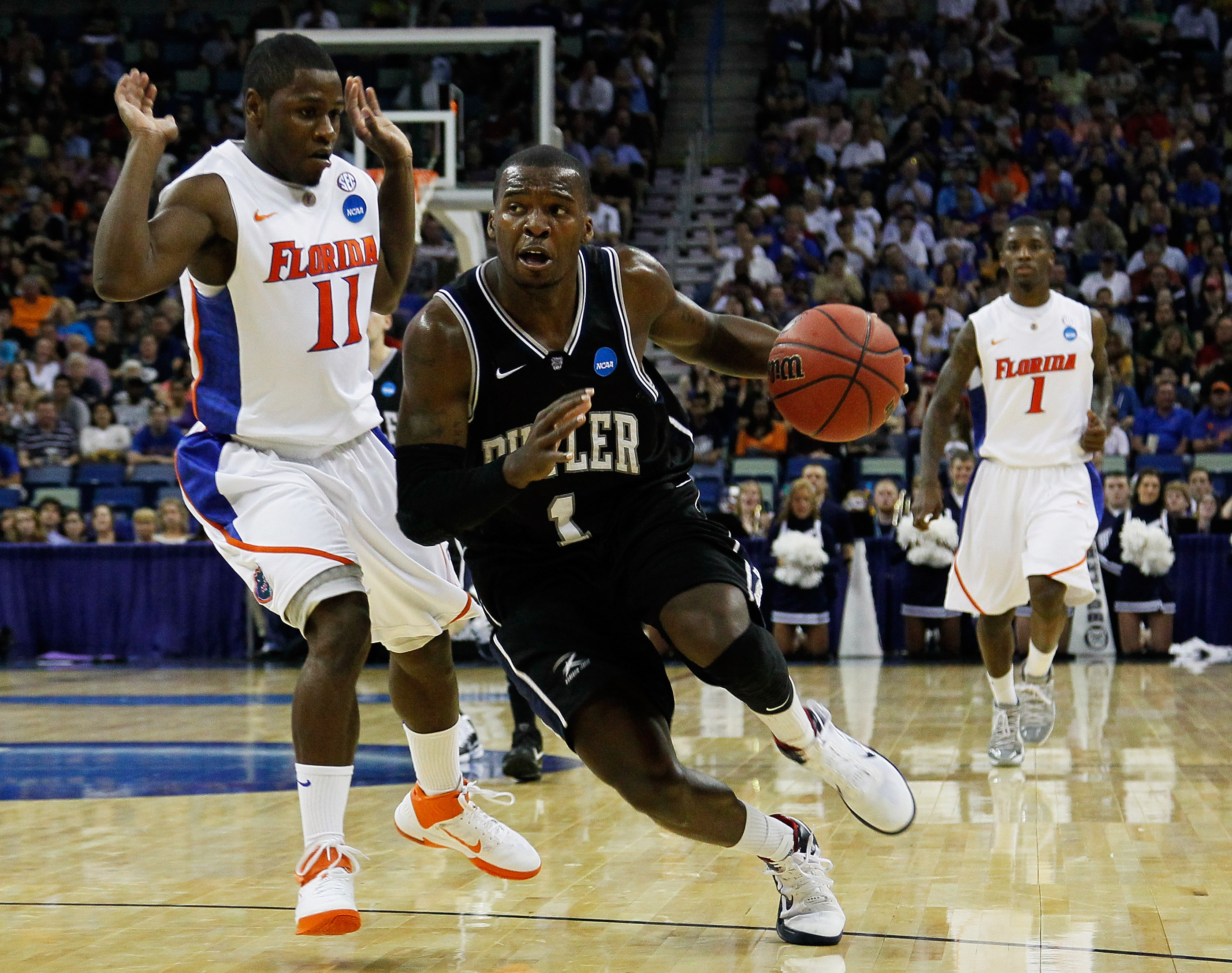 NEW ORLEANS, LA - MARCH 26: Shelvin Mack #1 of the Butler Bulldogs drives past Erving Walker #11 of the Florida Gators during the Southeast regional final of the 2011 NCAA men's basketball tournament at New Orleans Arena on March 26, 2011 in New Orleans,