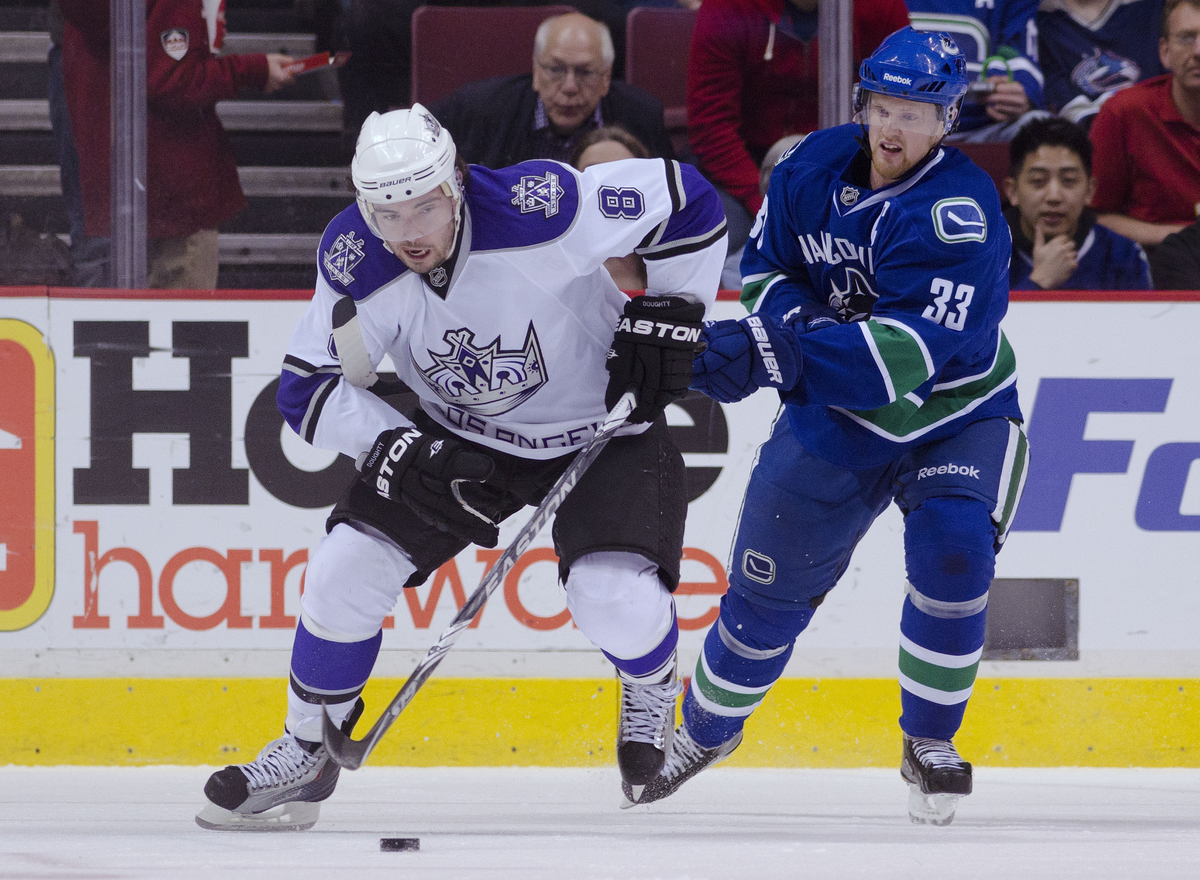 VANCOUVER, CANADA - MARCH 31: Henrik Sedin #33 of the Vancouver Canucks gets called for hooking Drew Doughty #8 of the Los Angeles Kings during the first period in NHL action on March 31, 2011 at Rogers Arena in Vancouver, BC, Canada.  (Photo by Rich Lam/