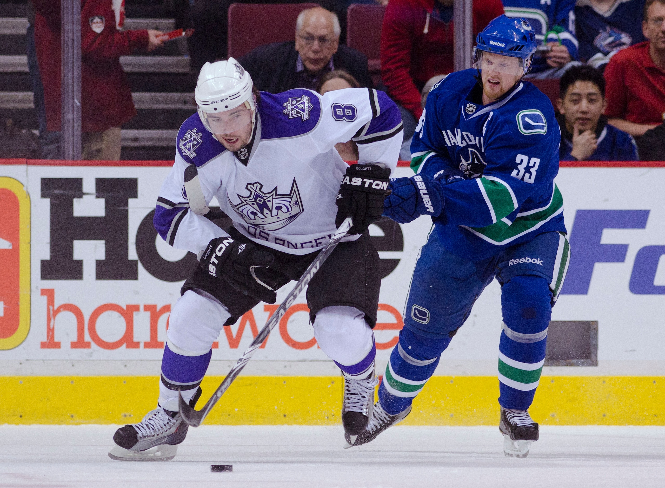 VANCOUVER, CANADA - MARCH 31: Henrik Sedin #33 of the Vancouver Canucks gets called for hooking Drew Doughty #8 of the Los Angeles Kings during the first period in NHL action on March 31, 2011 at Rogers Arena in Vancouver, BC, Canada.  (Photo by Rich Lam/