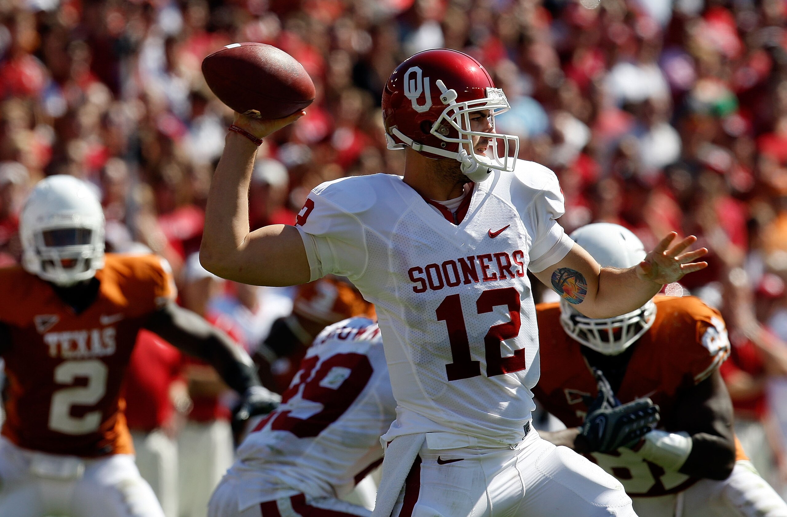 DALLAS - OCTOBER 17:  Quarterback Landry Jones #12 of the Oklahoma Sooners drops back to pass against the Texas Longhorns at Cotton Bowl on October 17, 2009 in Dallas, Texas.  (Photo by Ronald Martinez/Getty Images)