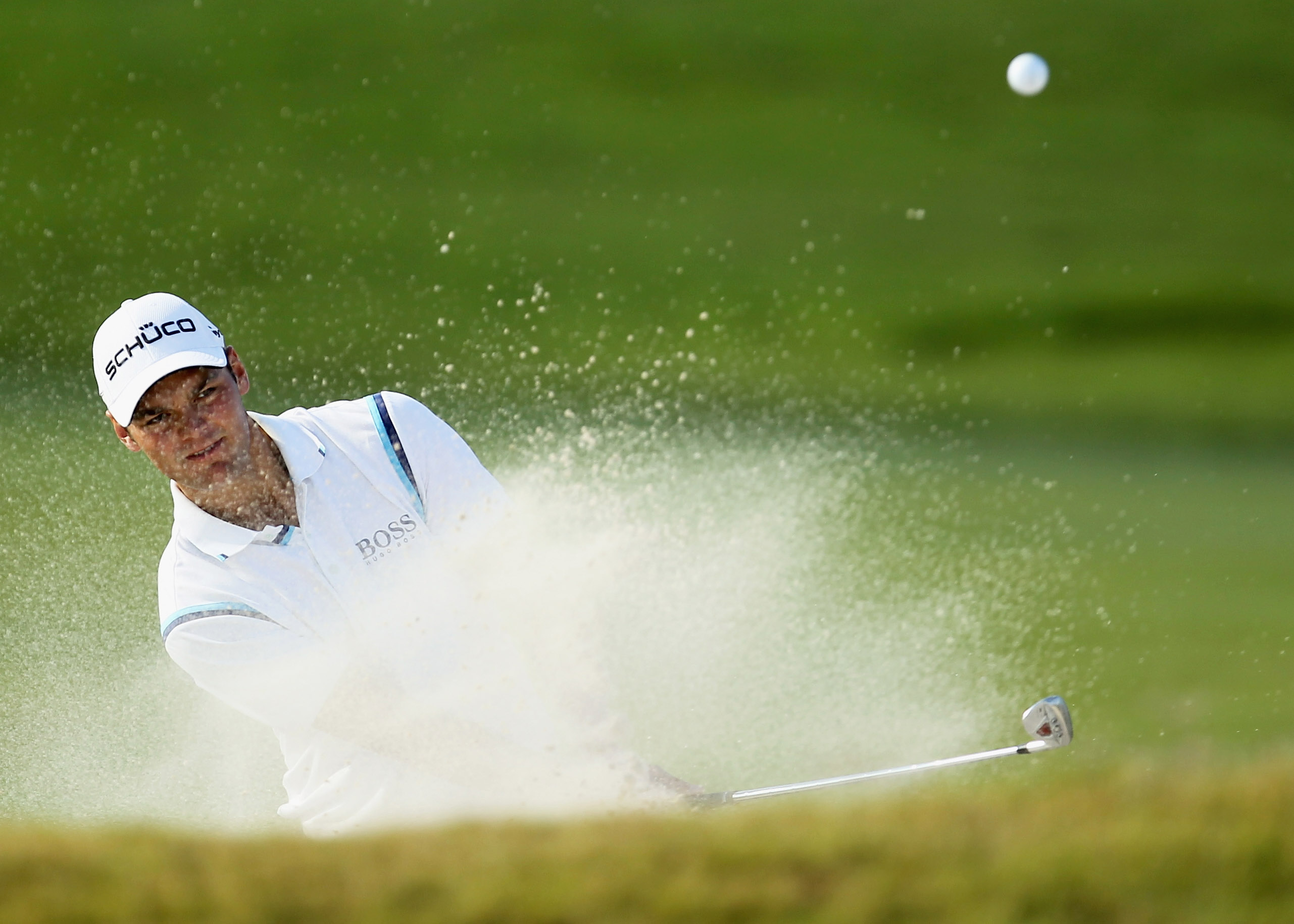 DORAL, FL - MARCH 12:  Martin Kaymer of Germany hits a bunker shot on the 16th hole during the third round of the 2011 WGC- Cadillac Championship at the TPC Blue Monster at the Doral Golf Resort and Spa on March 12, 2011 in Doral, Florida.  (Photo by Mike