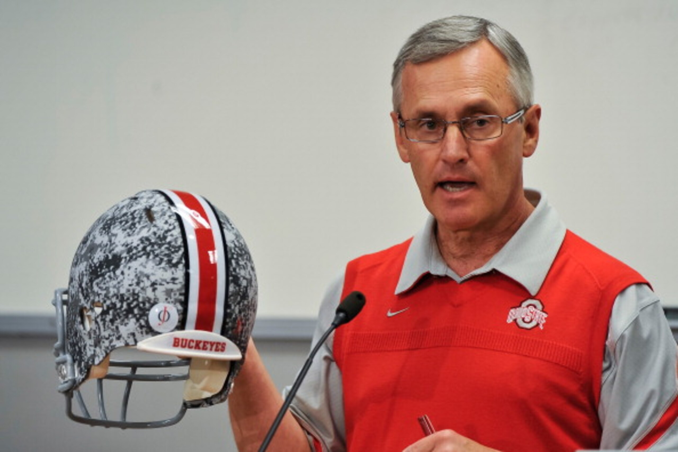 COLUMBUS, OH - MARCH 30:  Head Coach Jim Tressel shows off a football helmet with military camouflage to the media during a press conference before the start of Spring practices at the Woody Hayes Athletic Center at The Ohio State University on March 30,