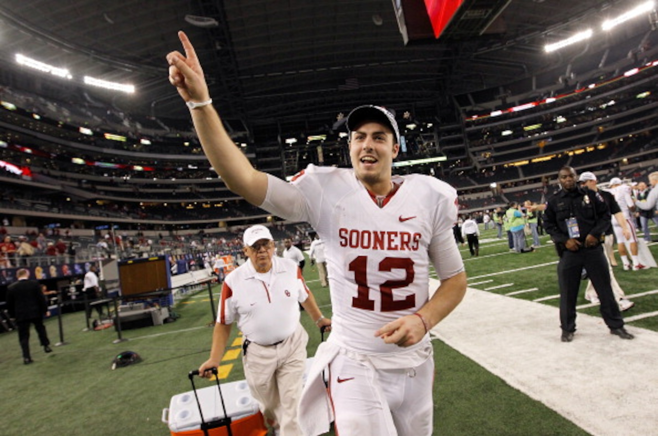 ARLINGTON, TX - DECEMBER 04:  Quarterback Landry Jones #12 of the Oklahoma Sooners celebrates after the Sooners beat the Nebraska Cornhuskers 23-20 at Cowboys Stadium on December 4, 2010 in Arlington, Texas.  (Photo by Tom Pennington/Getty Images)