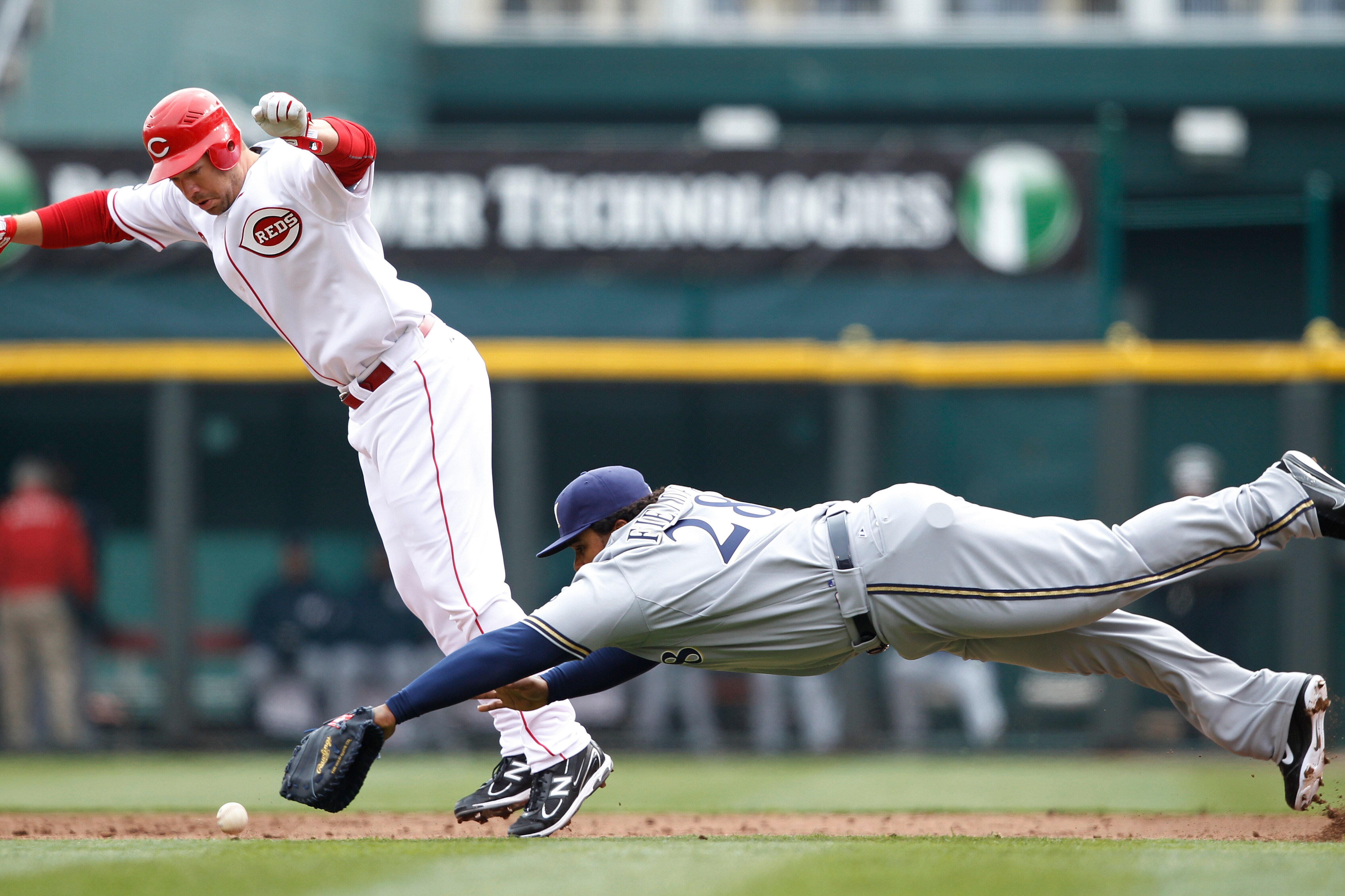 CINCINNATI, OH - MARCH 31: Scott Rolen #27 of the Cincinnati Reds tries to avoid Prince Fielder #28 of the Milwaukee Brewers on a ground ball during the opening day game at Great American Ballpark on March 31, 2011 in Cincinnati, Ohio. (Photo by Joe Robbi