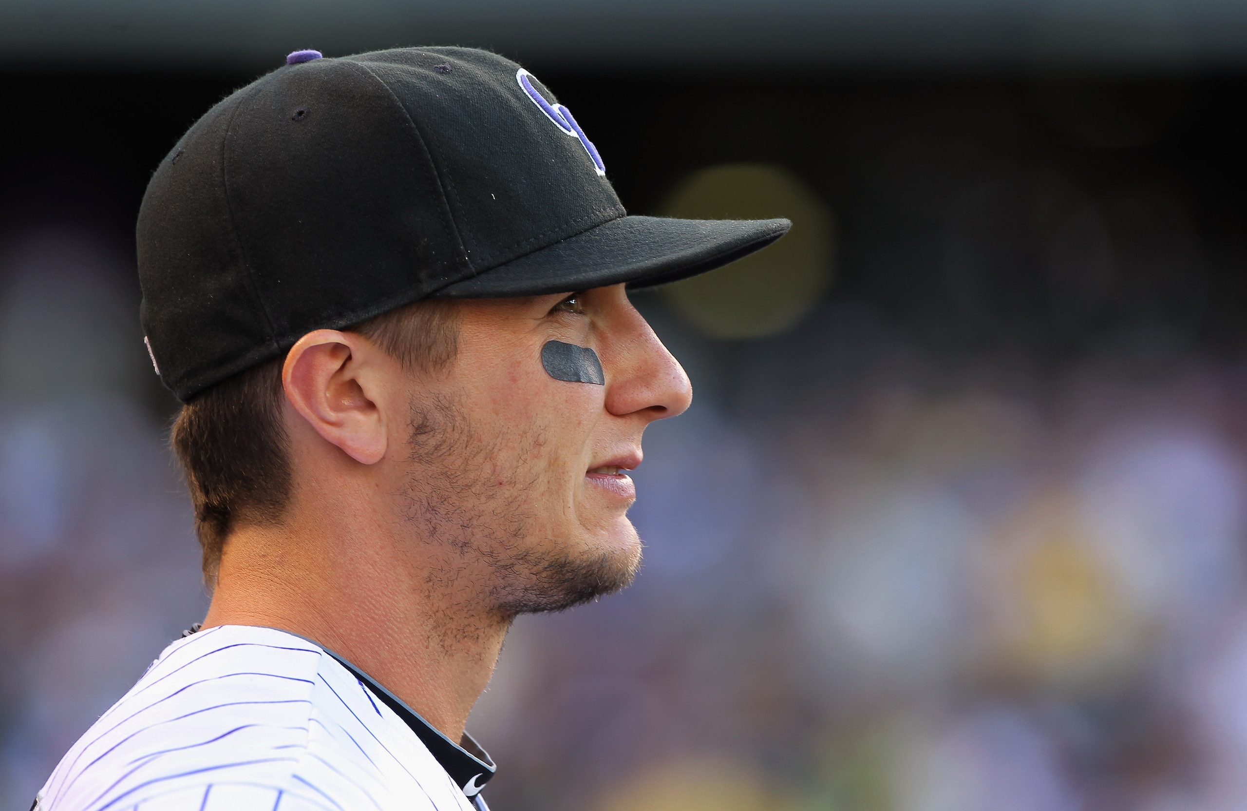 DENVER, CO - APRIL 02:  Troy Tulowitzki #2 of the Colorado Rockies looks on as he prepares to take the field against the Arizona Diamondbacks at Coors Field on April 2, 2011 in Denver, Colorado.  (Photo by Doug Pensinger/Getty Images)