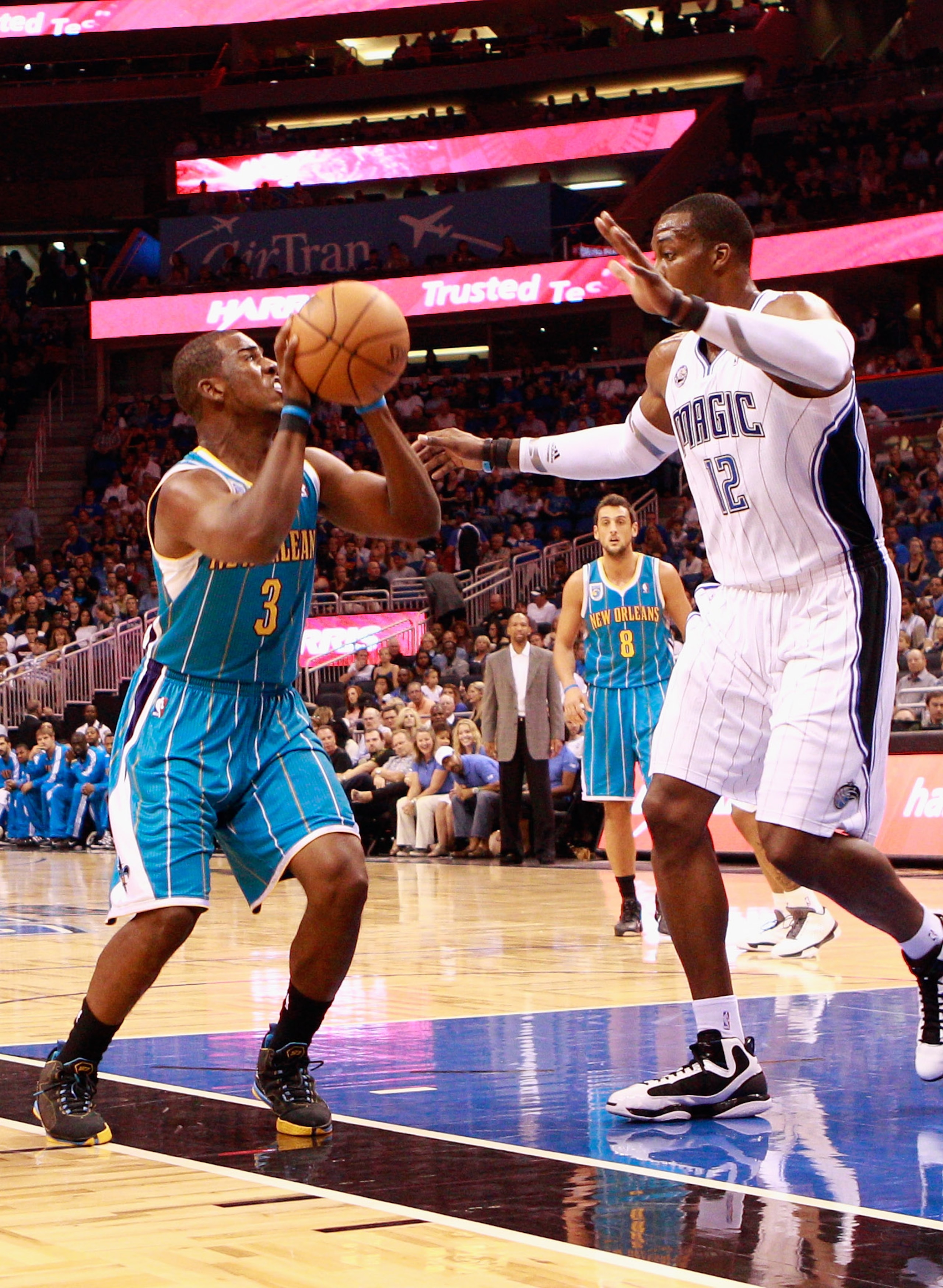 ORLANDO, FL - OCTOBER 10:  Chris Paul #3 of the New Orleans Hornets attempts a shot against Dwight Howard #12 of the Orlando Magic during the game at Amway Arena on October 10, 2010 in Orlando, Florida. NOTE TO USER: User expressly acknowledges and agrees