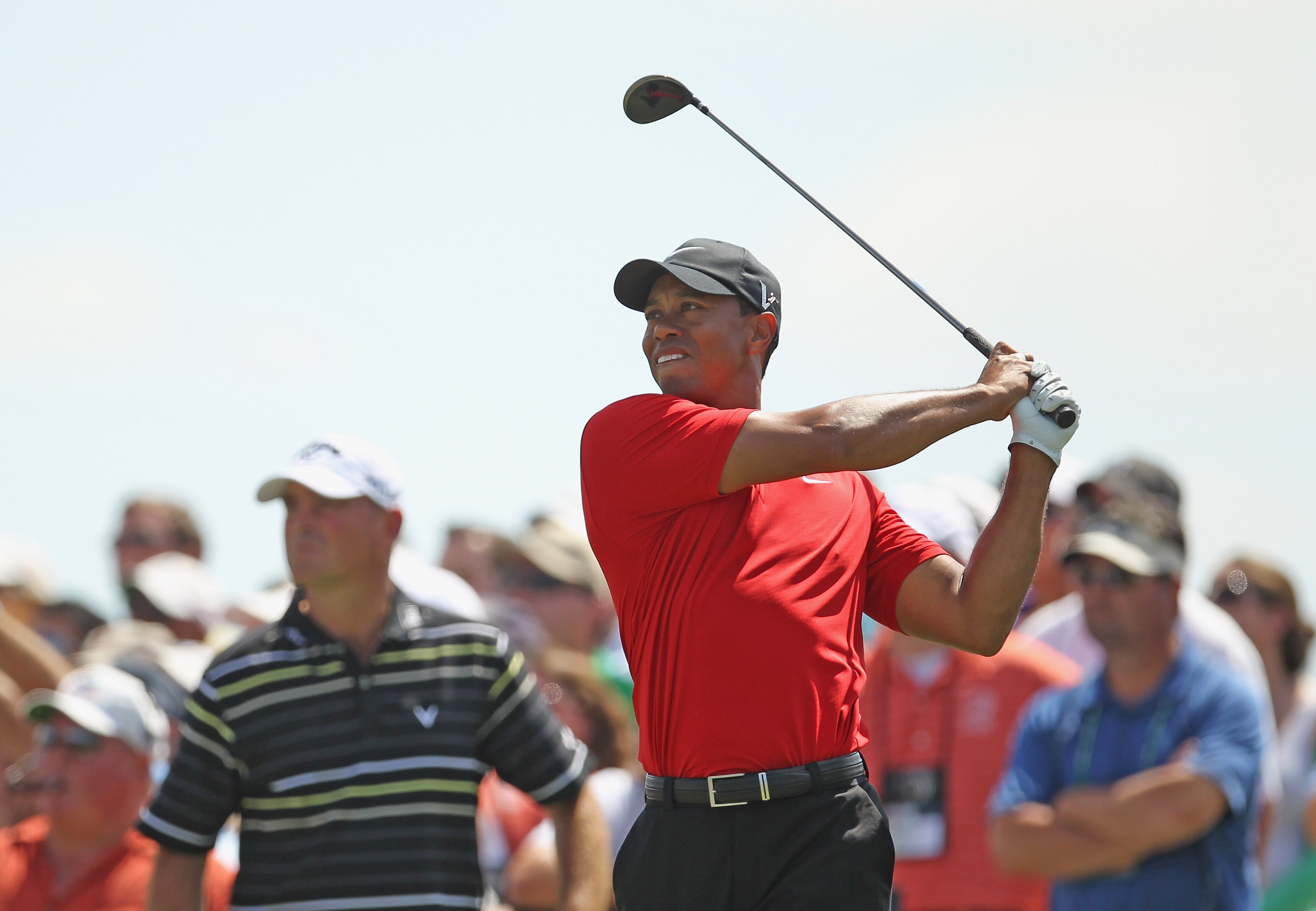 DORAL, FL - MARCH 13:  Tiger Woods watches his tee shot on the second hole as Thomas Bjorn of Denmark looks on during the final round of the 2011 WGC- Cadillac Championship at the TPC Blue Monster at the Doral Golf Resort and Spa on March 13, 2011 in Dora