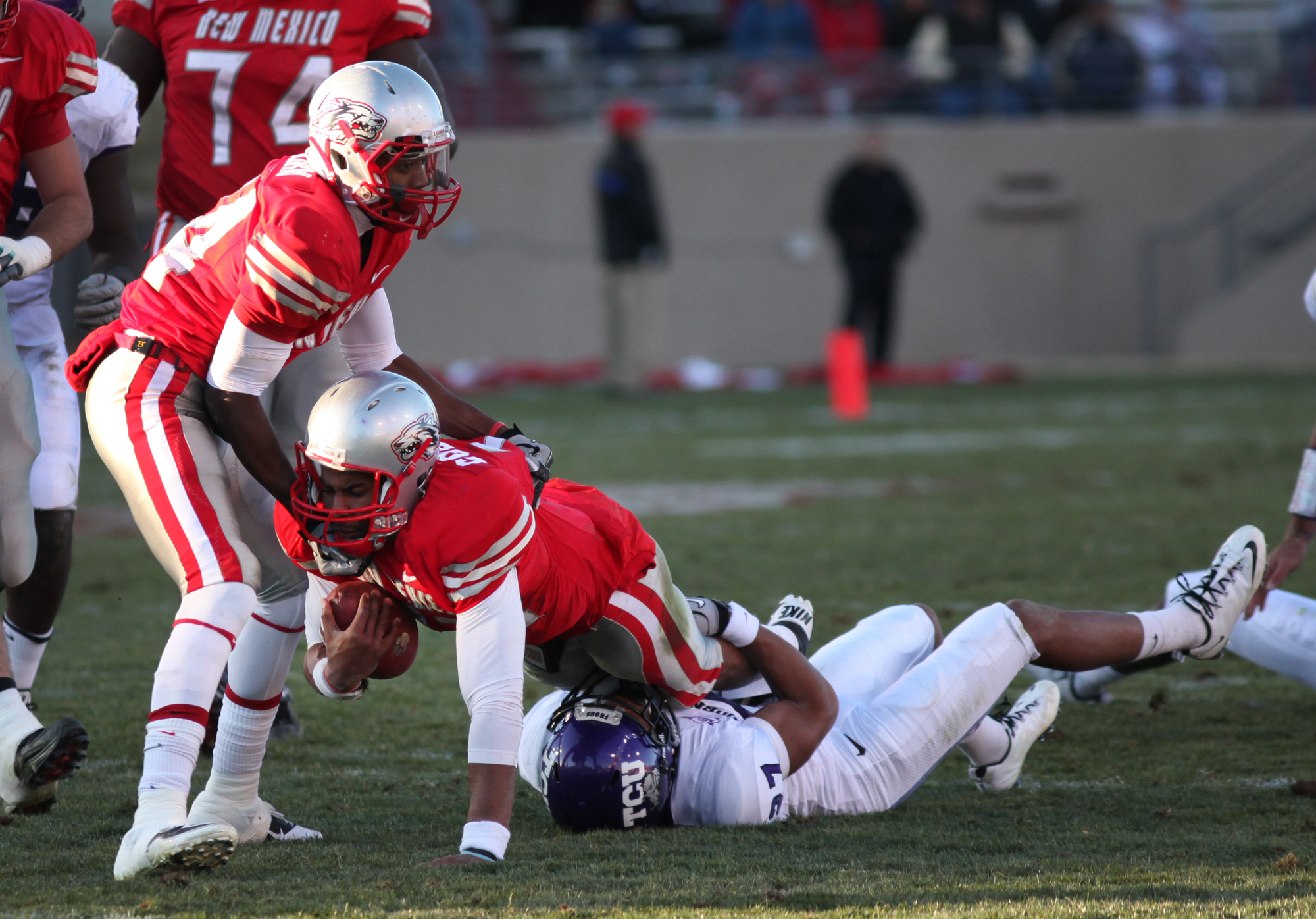 ALBUQUERQUE, NM - NOVEMBER 27: Quarterback Stump Godfrey #11 of the University of New Mexico Lobos is tackled by Jason Teague #27 of the TCU Horned Frogs on November 27, 2010 at University Stadium in Albuquerque, New Mexico. TCU won 66-17. (Photo by Eric
