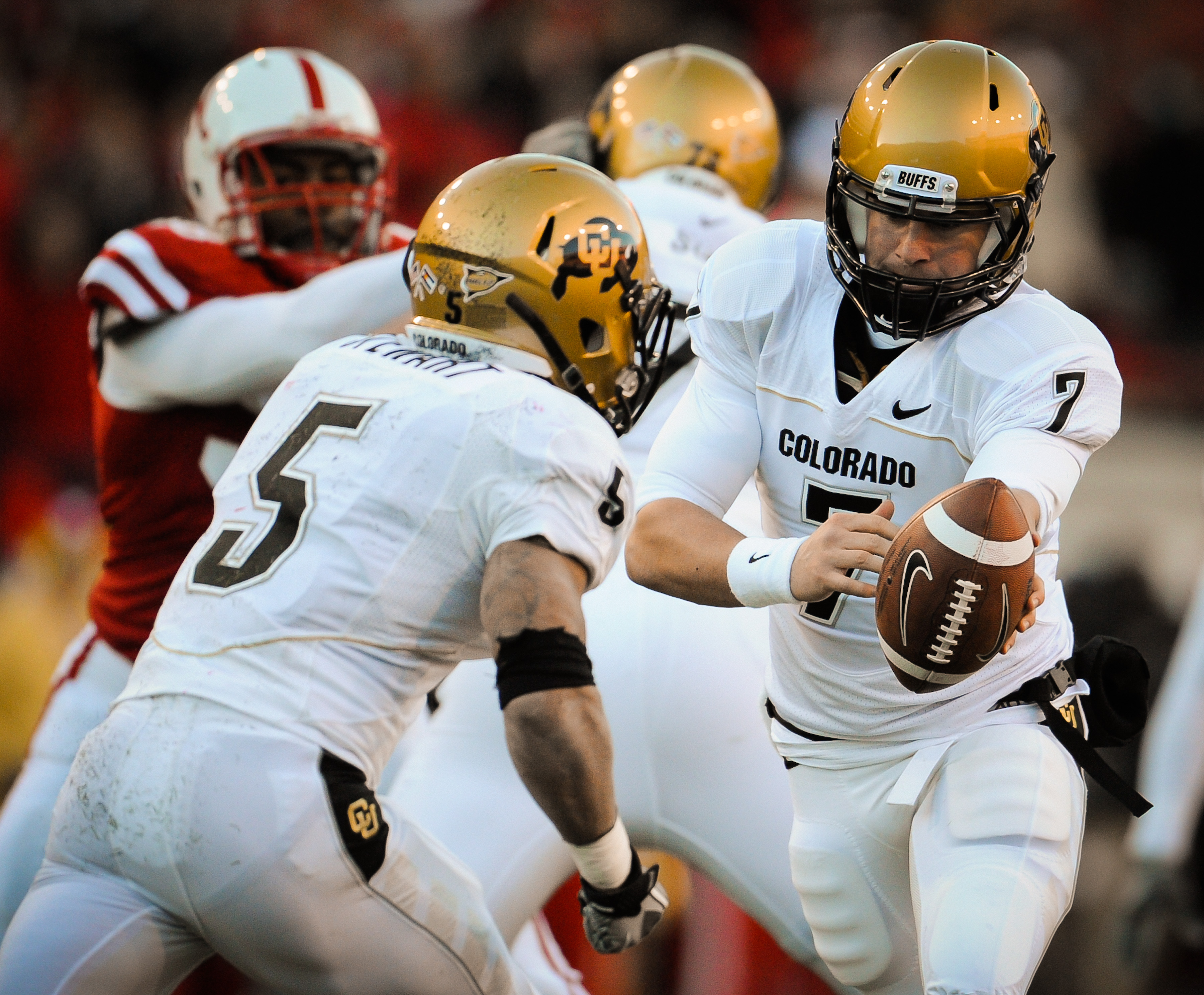 LINCOLN, NE - NOVEMBER 26: Cody Hawkins #7 hands the ball to teammate Rodney Stewart #5 of the Colorado Buffaloes during their game against the Colorado Buffaloes at Memorial Stadium on November 26, 2010 in Lincoln, Nebraska. Nebraska defeated Colorado 45