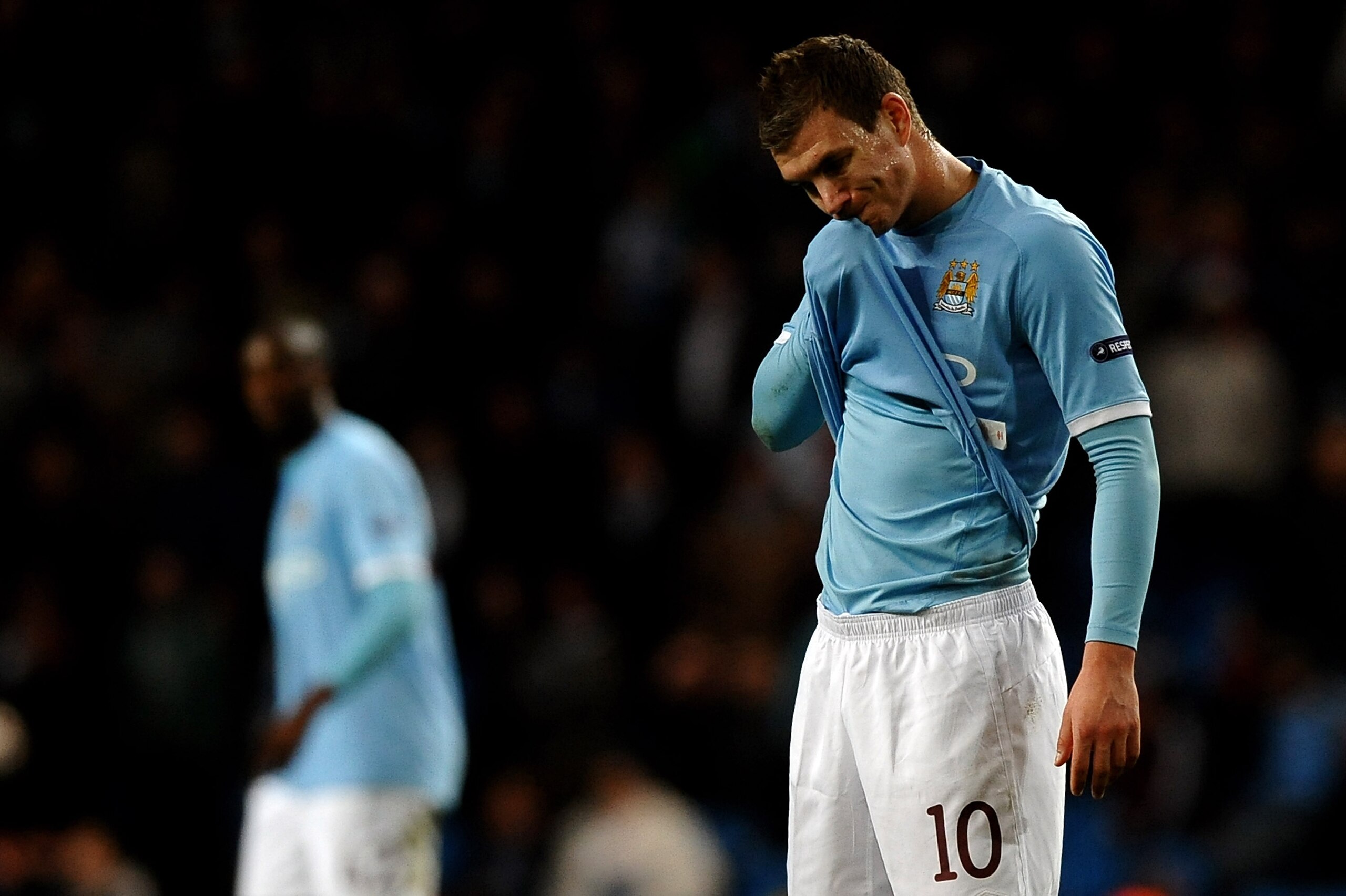MANCHESTER, ENGLAND - MARCH 17:  Edin Dzeko of Manchester City shows his dejection during the UEFA Europa League round of 16 second leg match between Manchester City and Dynamo Kiev at City of Manchester Stadium on March 17, 2011 in Manchester, England.  