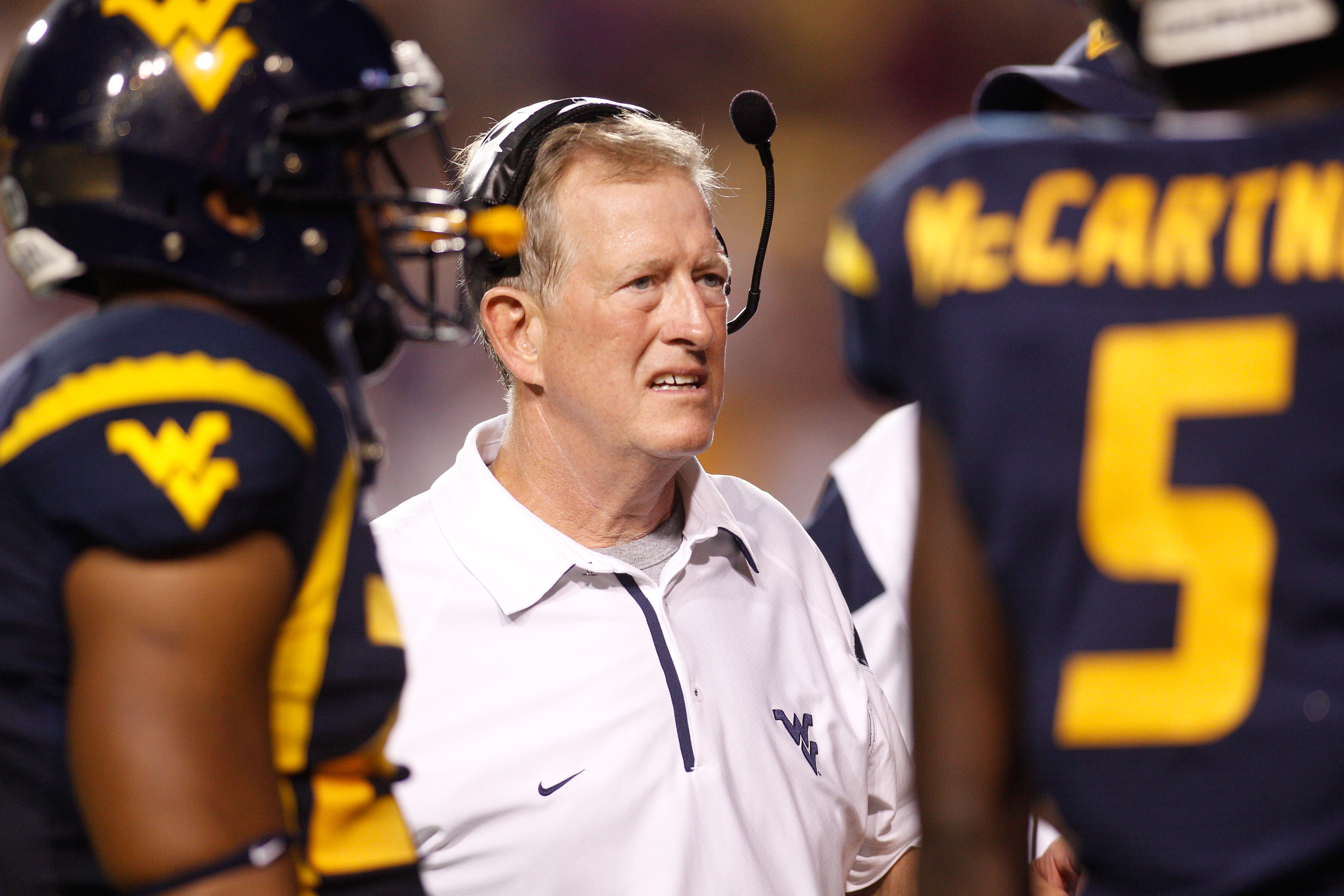 BATON ROUGE, LA - SEPTEMBER 25:  Head coach Bill Stewart of the West Virginia Mountaineers talks with his team during a timeout against the  Louisiana State University Tigers at Tiger Stadium on September 25, 2010 in Baton Rouge, Louisiana.  The Tigers de