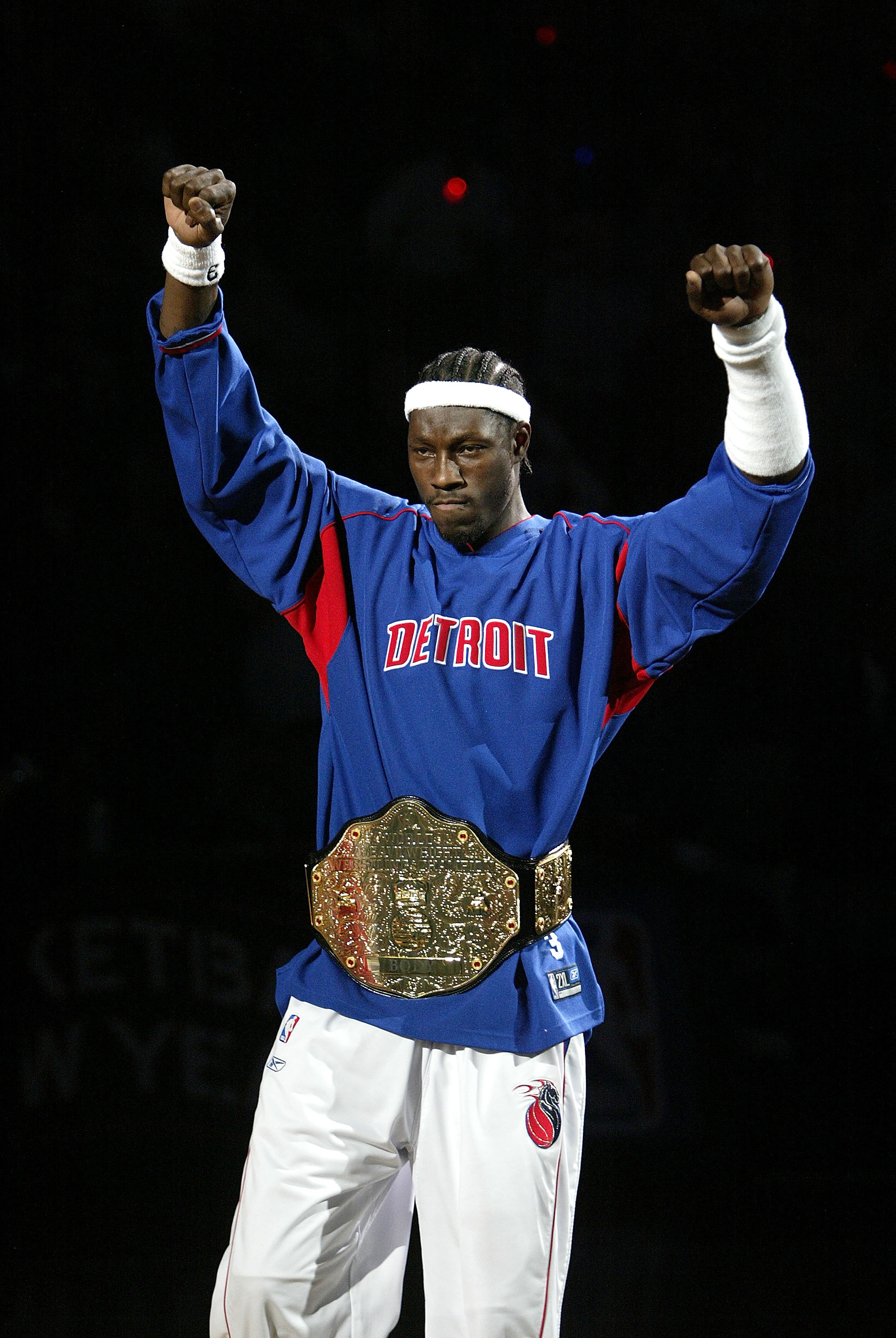 AUBURN HILLS, MI - NOVEMBER 2: Ben Wallace #3 of the Detroit Pistons raises his arms after being introduced to a sellout crowd as the NBA defending champion Detroit Pistons hold a pregame ceremony before their game against the Houston Rockets on November