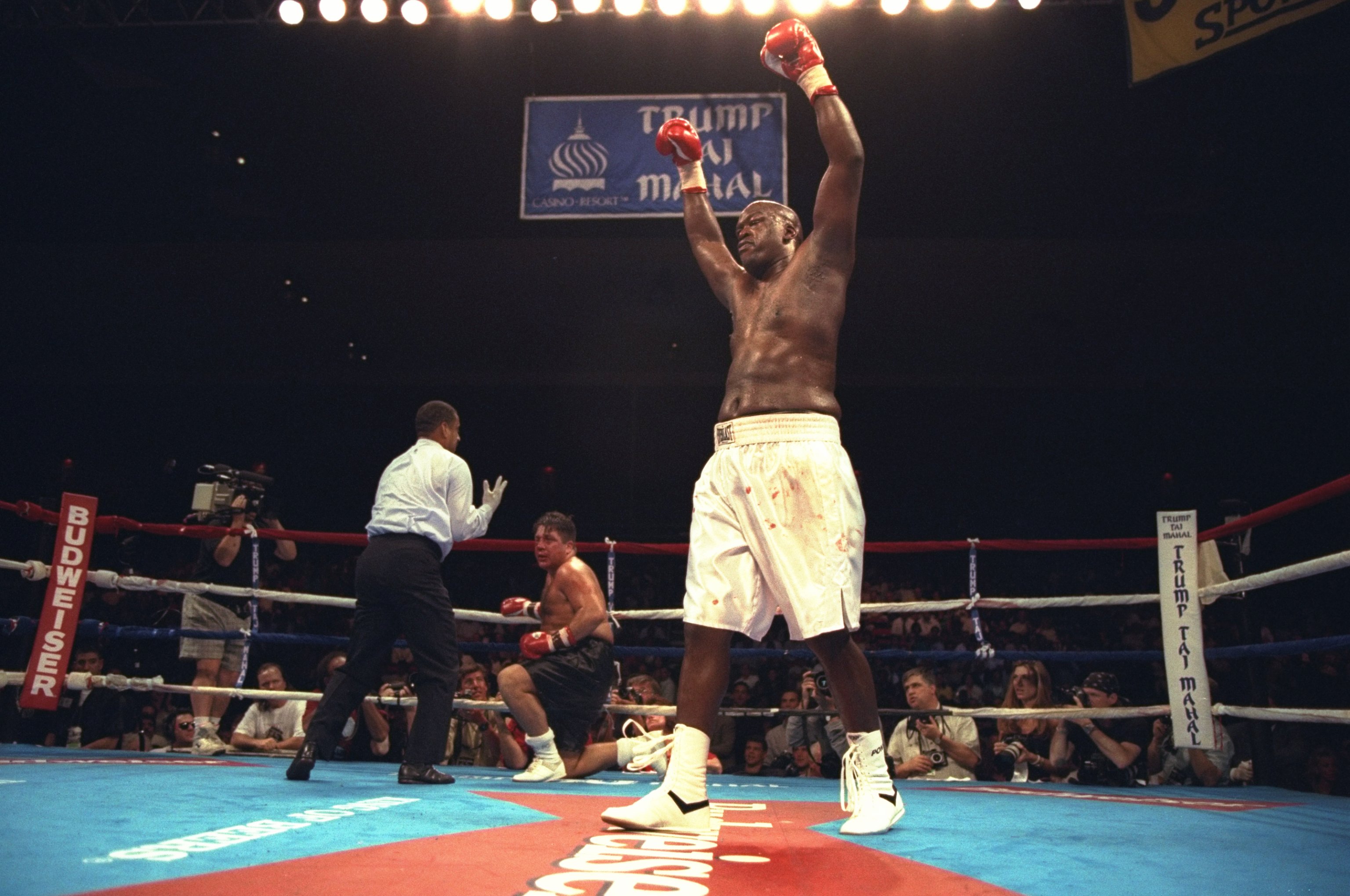 22 Jul 1996: Buster Douglas celebrates after knocking down Tony La Rosa during the Buster Douglas v Tony La Rosa fight at the Trump Taj Mahal in Atlantic City, New Jersey. Douglas won the fight fight in the third round by TKO.