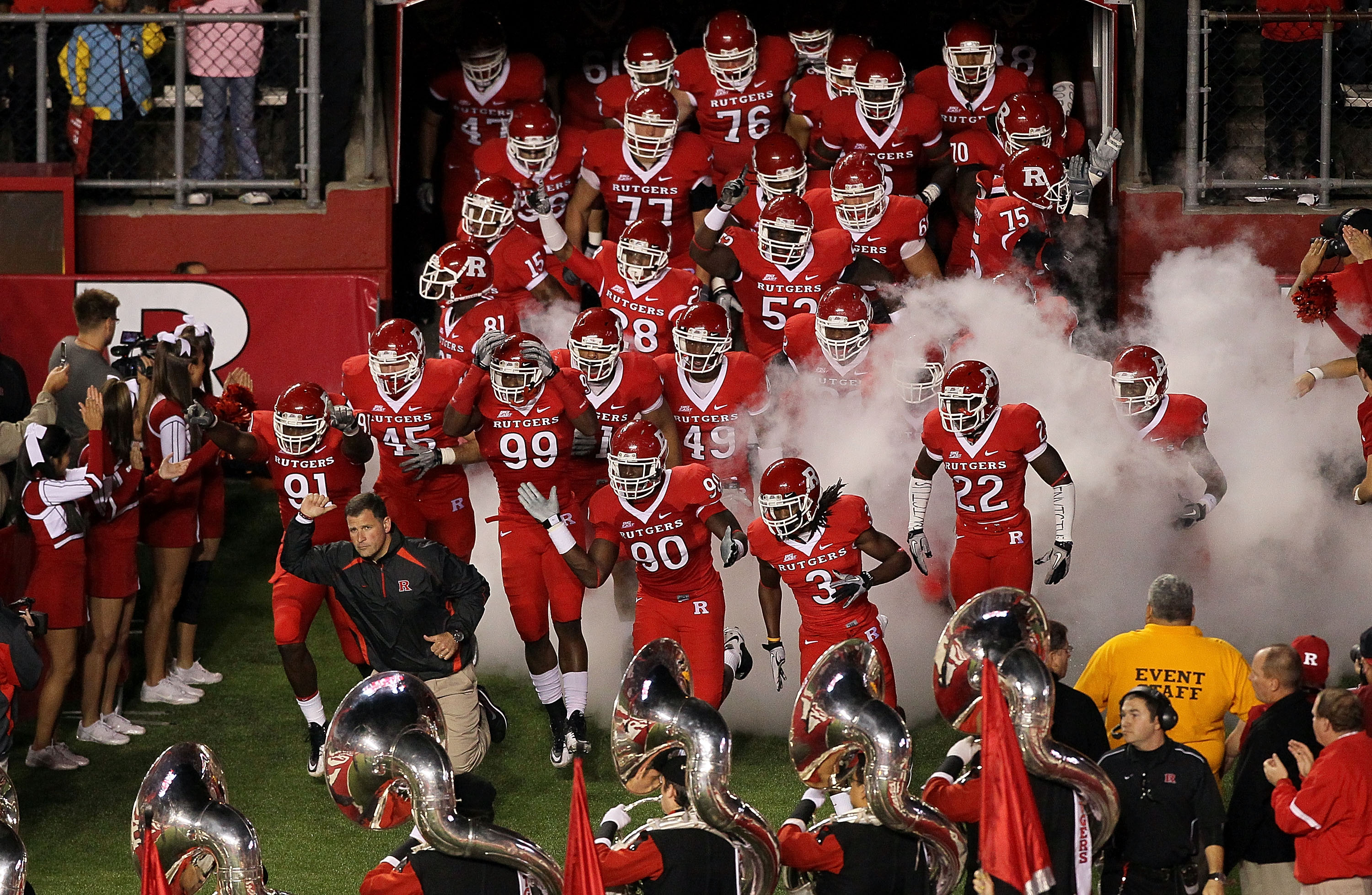 PISCATAWAY, NJ - OCTOBER 08:  Head coach Greg Schiano of the Rutgers Scarlet Knights leads his team onto the field to play against the Connecticut Huskies at Rutgers Stadium on October 8, 2010 in Piscataway, New Jersey.  (Photo by Jim McIsaac/Getty Images