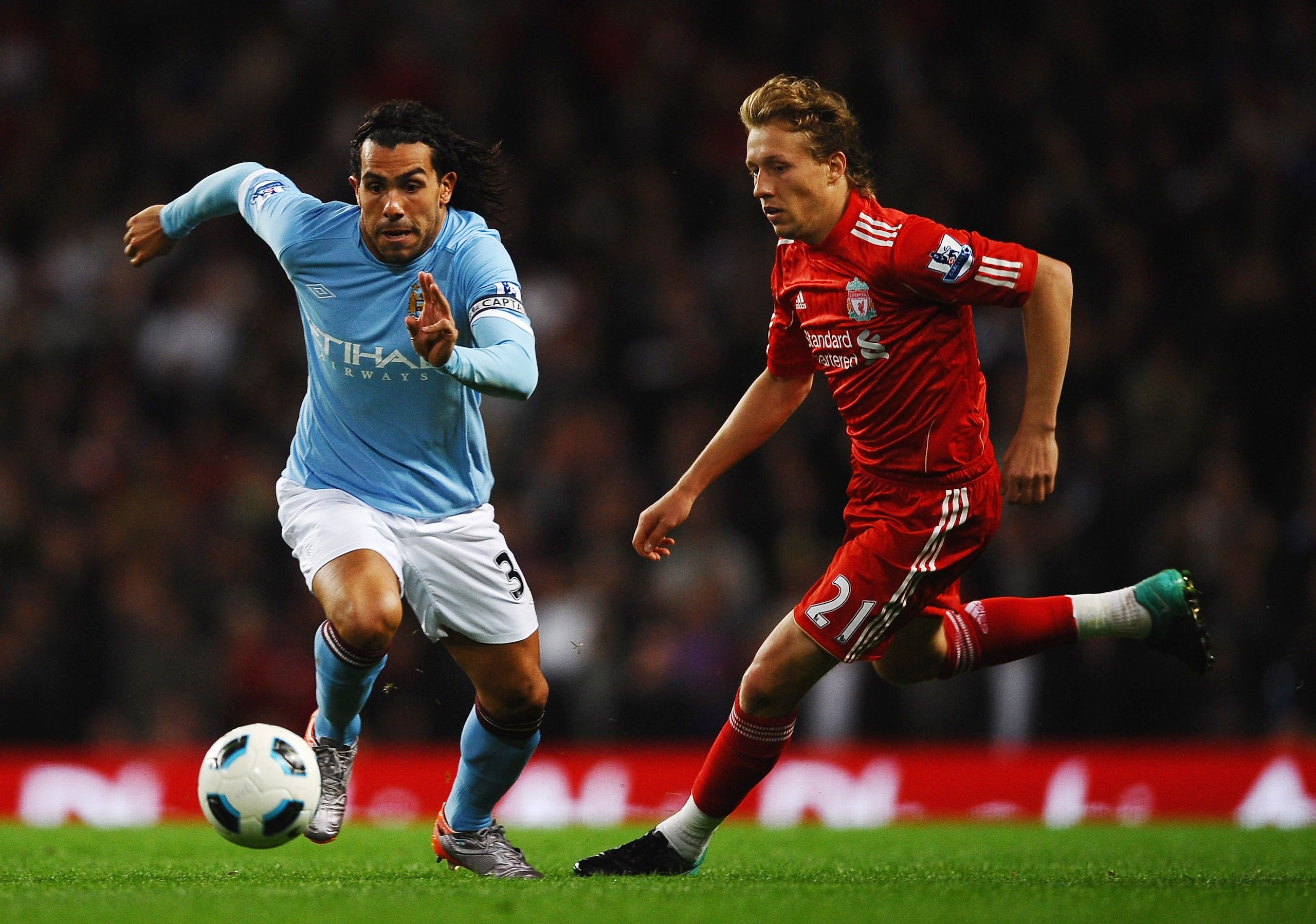 MANCHESTER, ENGLAND - AUGUST 23: Carlos Tevez of Manchester City battles for the ball with Lucas of Liverpool during the Barclays Premier League match between Manchester City and Liverpool at City of Manchester Stadium on August 23, 2010 in Manchester, En