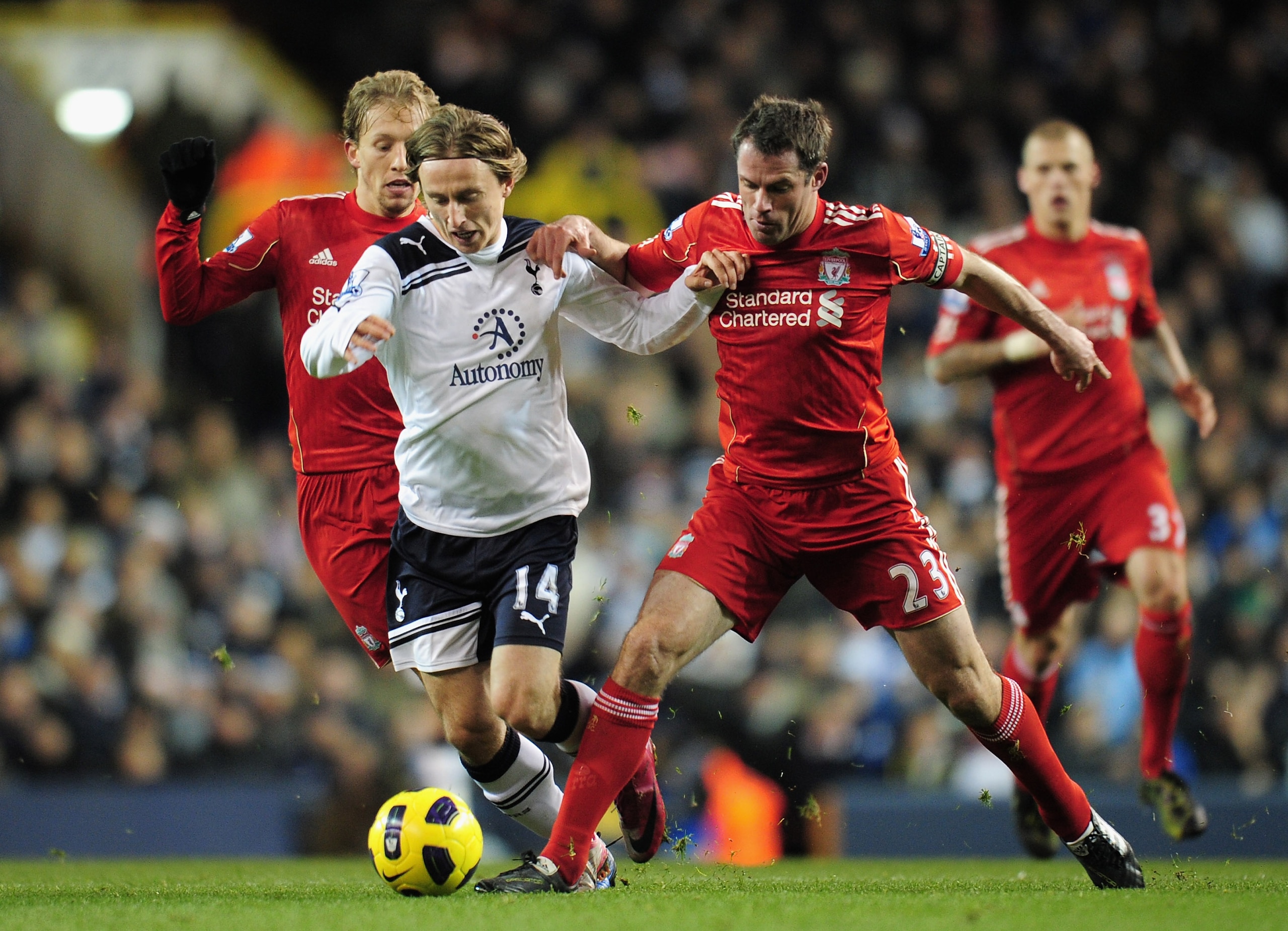 LONDON, ENGLAND - NOVEMBER 28:  Luka Modric of Tottenham Hotspur is tackled by Jamie Carragher of Liverpool during the Barclays Premier League match between Tottenham Hotspur and Liverpool at White Hart Lane on November 28, 2010 in London, England.  (Phot