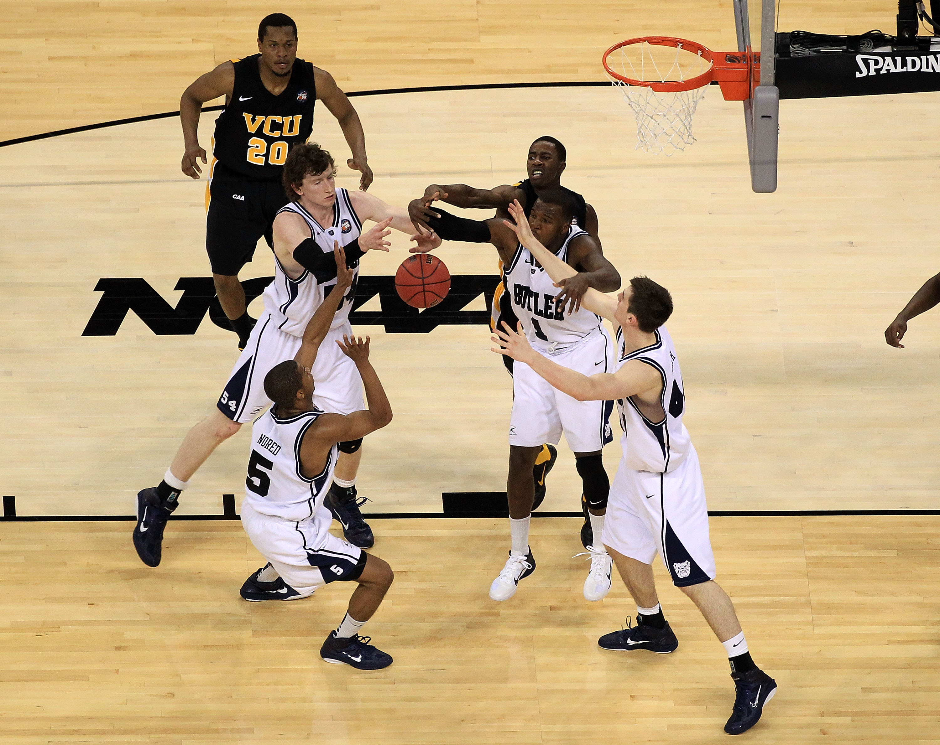 HOUSTON, TX - APRIL 02: Rob Brandenberg #23 of the Virginia Commonwealth Rams fights for the ball against Ronald Nored #5, Andrew Smith #44, Matt Howard #54 and Shelvin Mack #1 of the Butler Bulldogs during the National Semifinal game of the 2011 NCAA Di