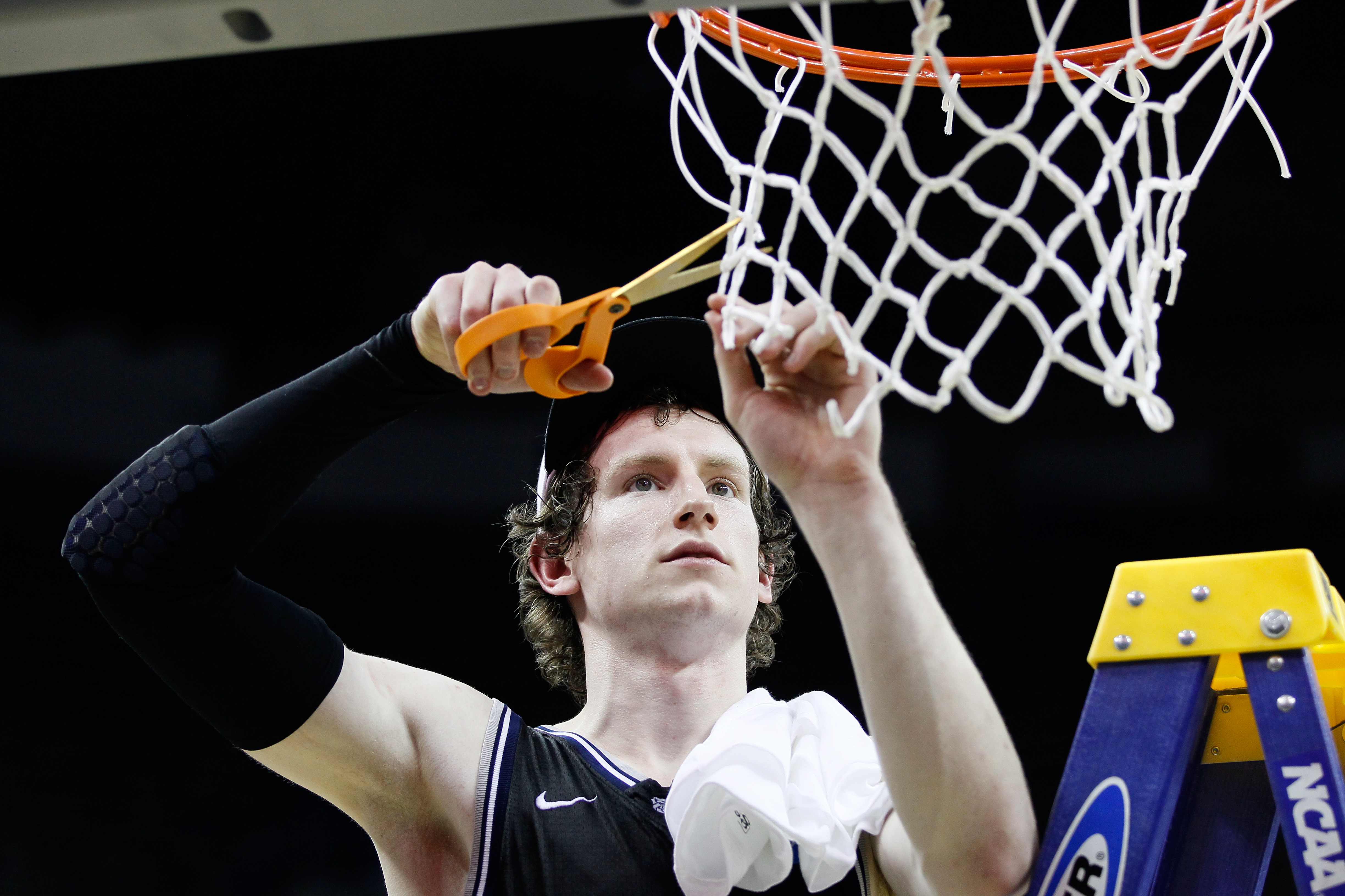 NEW ORLEANS, LA - MARCH 26: Matt Howard #54 of the Butler Bulldogs celebrates defeating the Florida Gators 74 to 71 in overtime by cutting down part of the net during the Southeast regional final of the 2011 NCAA men's basketball tournament at New Orlean
