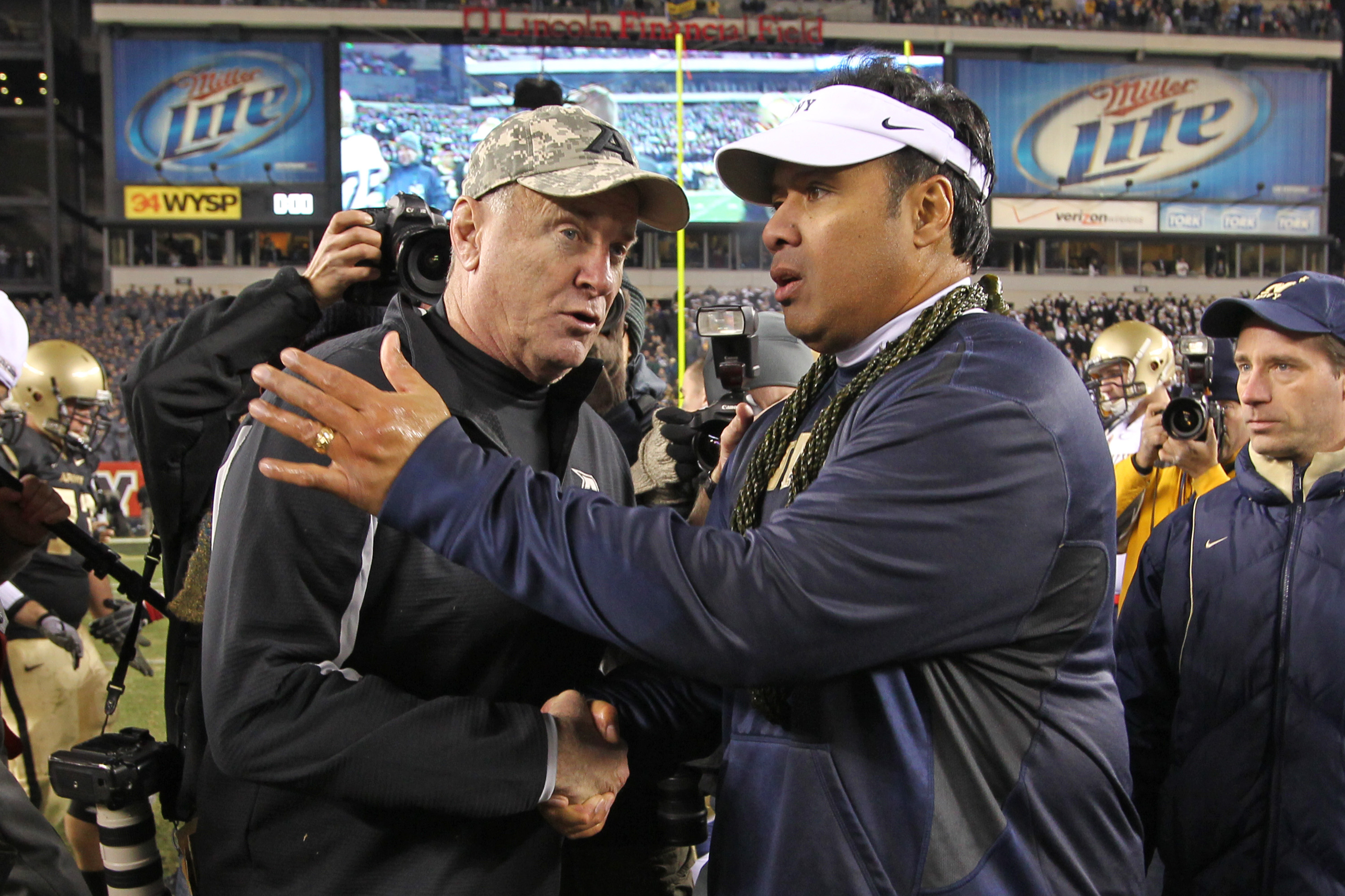PHILADELPHIA - DECEMBER 11: Head coach Rich Ellerson of the Army Black Knights (L) shakes hands with head coach Ken Niumatalolo of the Navy Midshipmen after a game on December 11, 2010 at Lincoln Financial Field in Philadelphia, Pennsylvania. The Midshipm