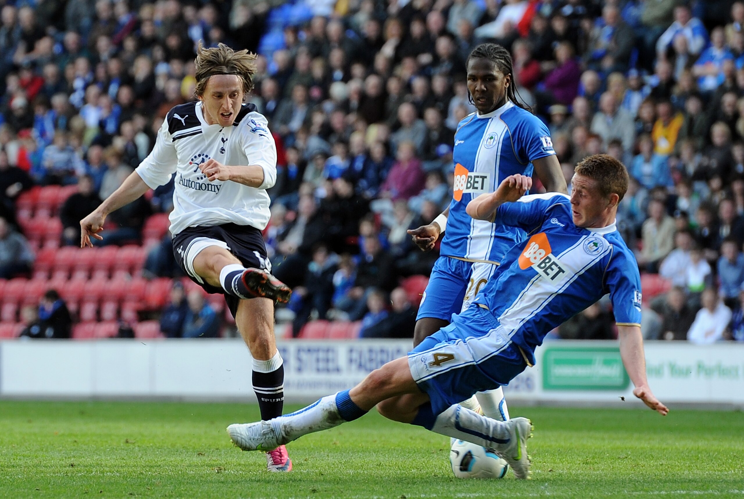 WIGAN, ENGLAND - APRIL 02: Luka Modric(L) of Tottenham Hotspur shoots at goal as James McCarthy of Wigan Athletic blocks during the Barclays Premier League match between Wigan Athletic and Tottenham Hotspur at DW Stadium on April 2, 2011 in Wigan, England WIGAN, ENGLAND - APRIL 02: Luka Modric(L) of Tottenham Hotspur shoots at goal as James McCarthy of Wigan Athletic blocks during the Barclays Premier League match between Wigan Athletic and Tottenham Hotspur at DW Stadium on April 2, 2011 in Wigan, England