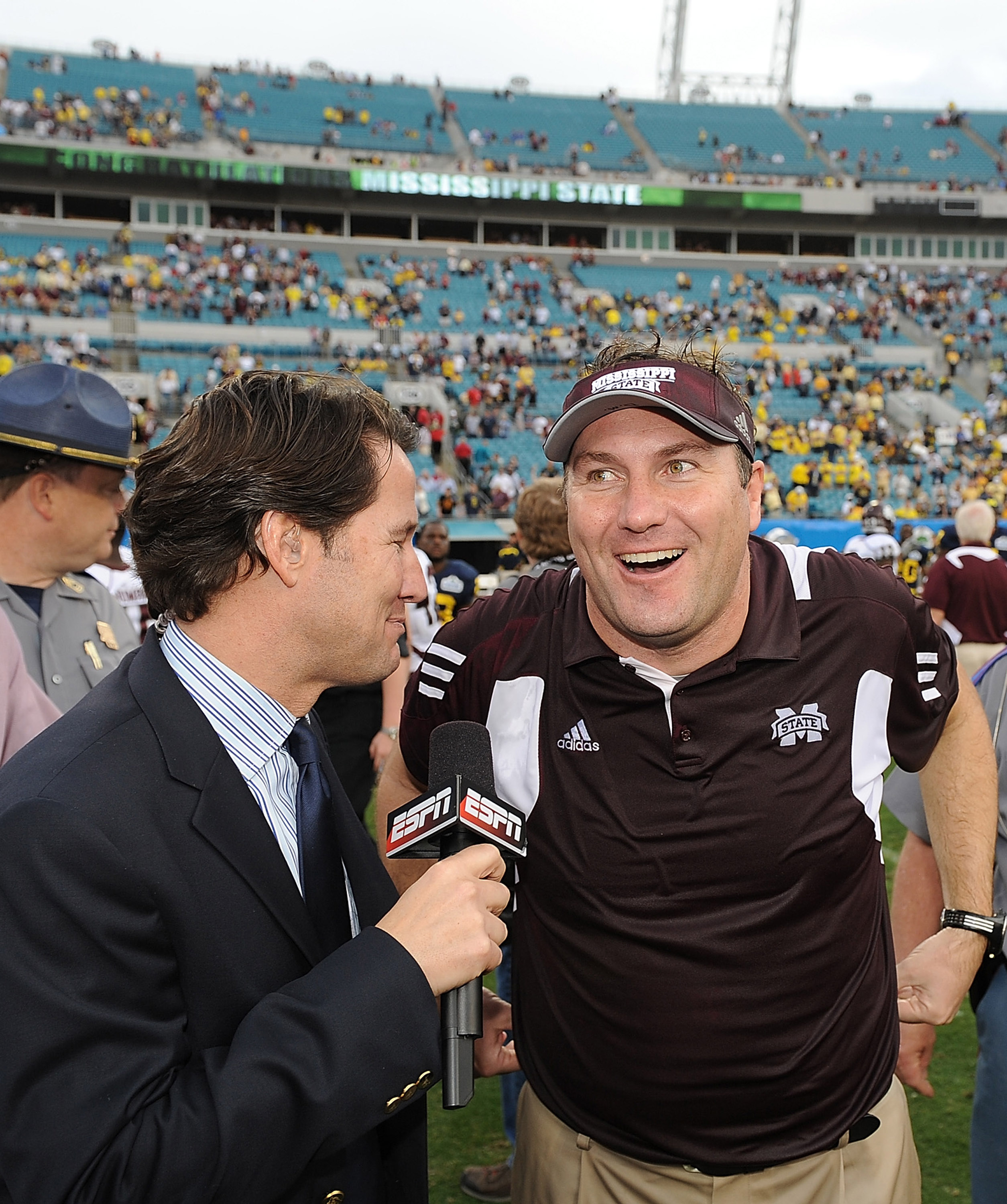 JACKSONVILLE, FL - JANUARY 01:  Mississippi State head coach Dan Mullens is interviewed by ESPN following the Bulldogs victory over the Michigan Wolverines during the Gator Bowl at EverBank Field on January 1, 2011 in Jacksonville, Florida  (Photo by Rick