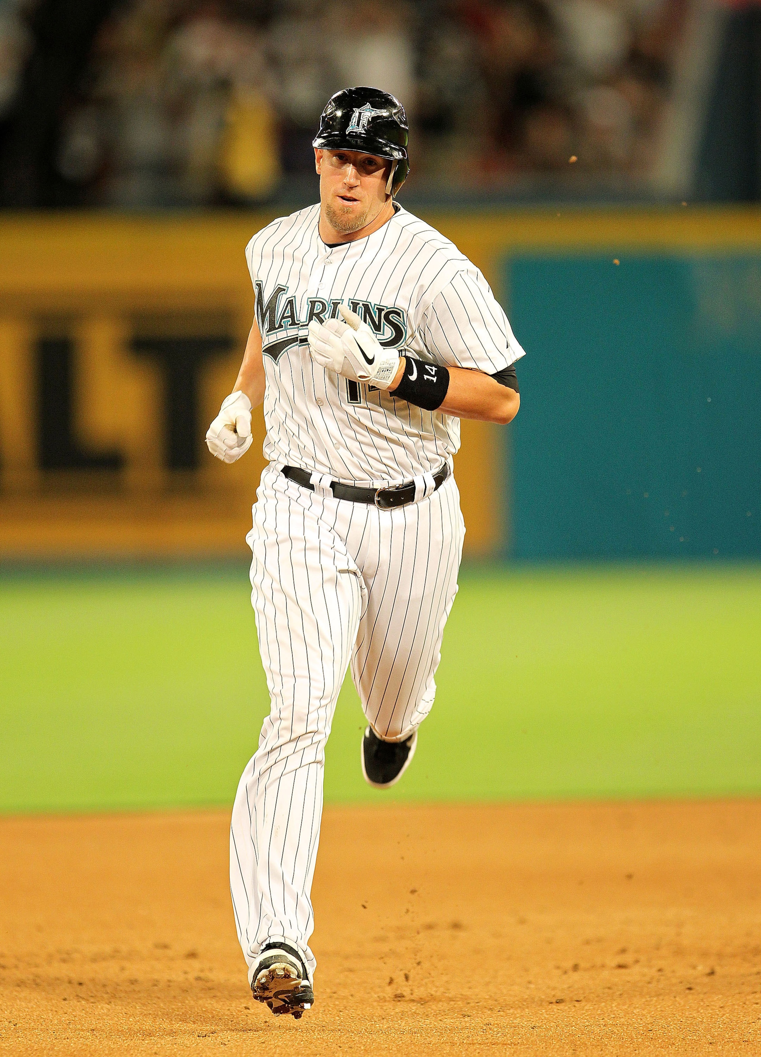 MIAMI GARDENS, FL - APRIL 01: John Buck #14 of the Florida Marlins rounds second after hitting a grand slam during opening day against the New York Mets at Sun Life Stadium on April 1, 2011 in Miami Gardens, Florida.  (Photo by Mike Ehrmann/Getty Images)