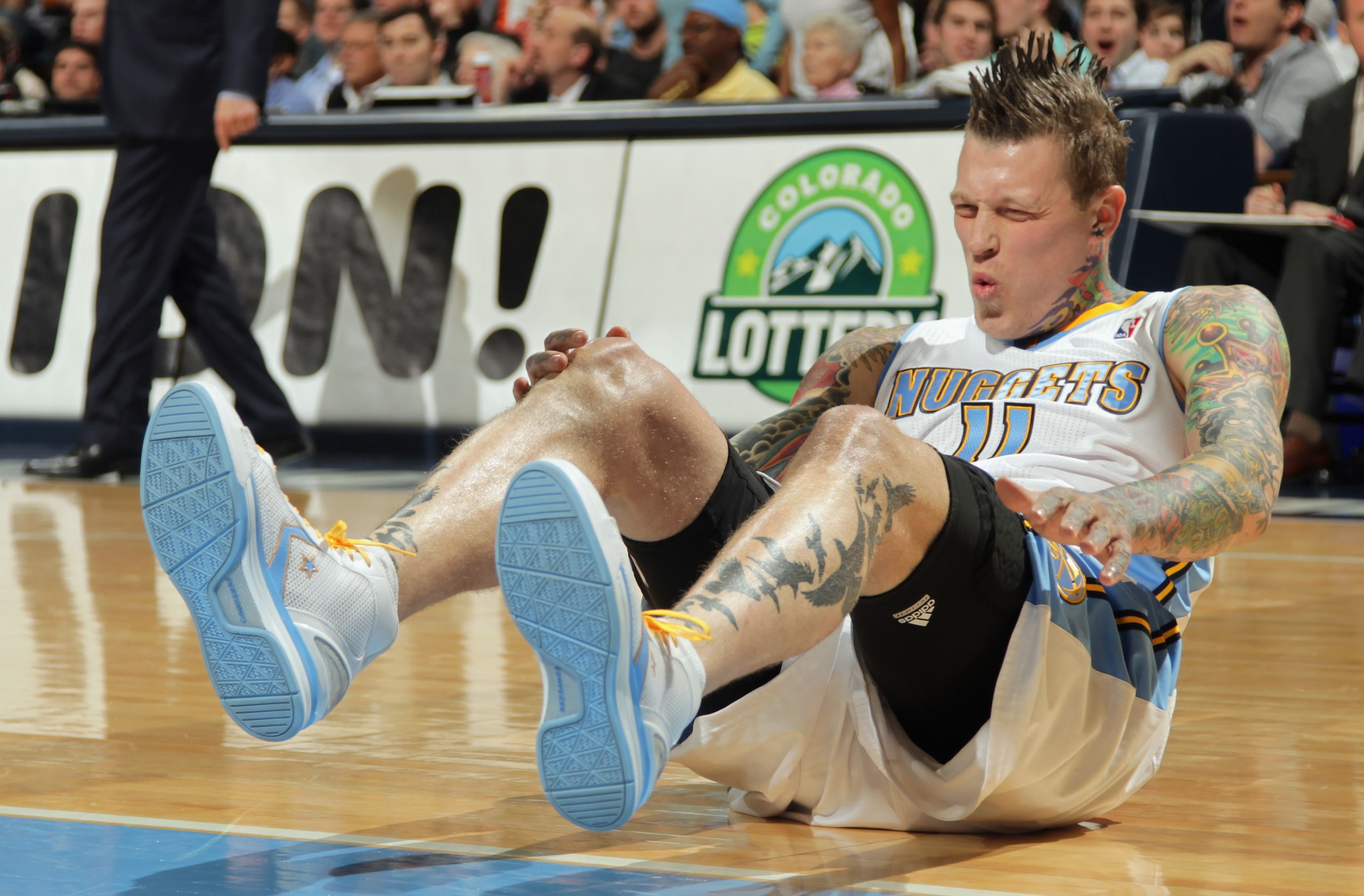 DENVER, CO - MARCH 21:  Chris Andersen #11 of the Denver Nuggets grabs his knee and grimaces as he falls to the court after blocking a shot against the Toronto Raptors at the Pepsi Center on March 21, 2011 in Denver, Colorado. The Nuggets defeated the Rap