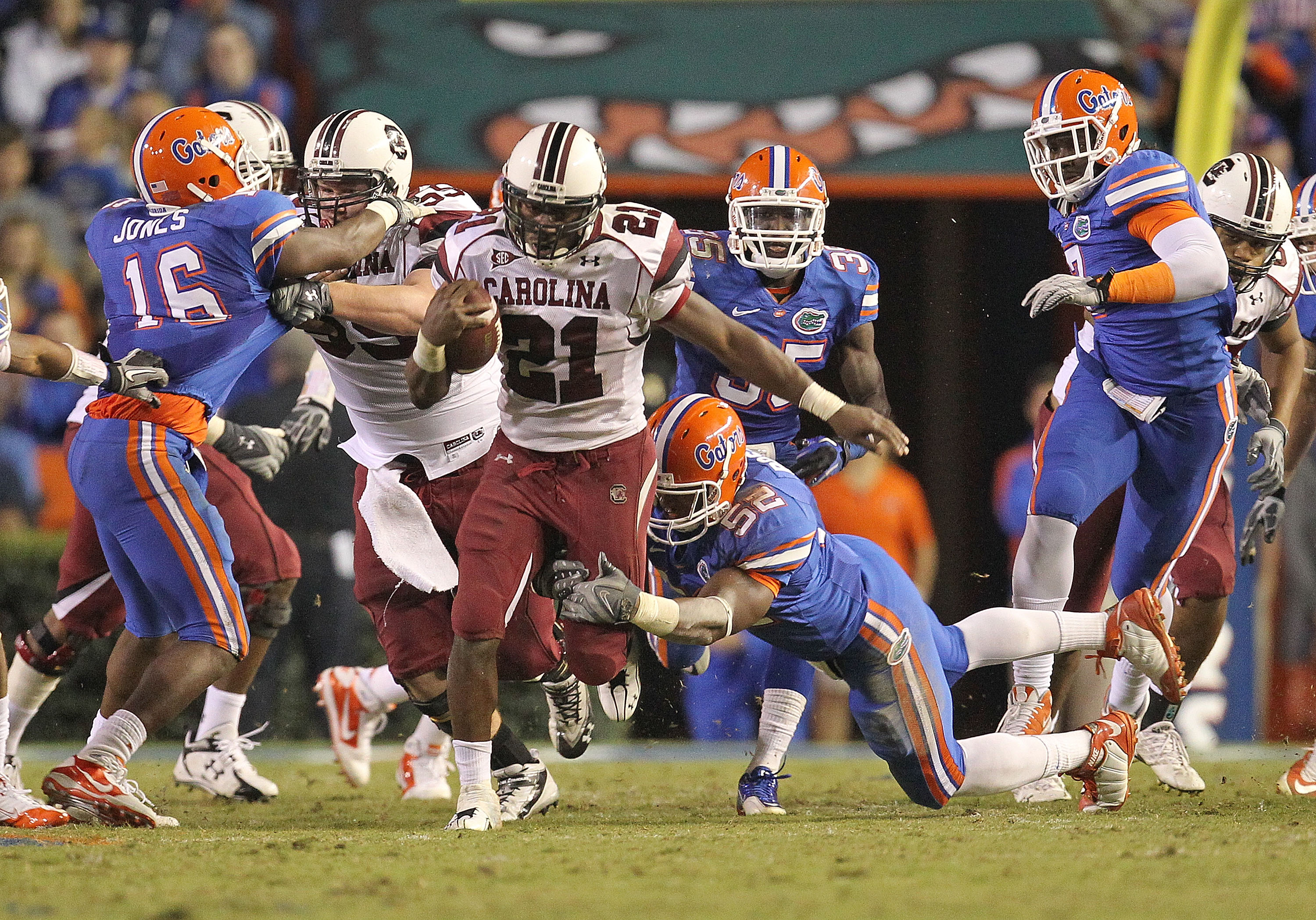 GAINESVILLE, FL - NOVEMBER 13:  Marcus Lattimore #21 of the South Carolina Gamecocks rushes against Jonathan Bostic #52 of the Florida Gators at Ben Hill Griffin Stadium on November 13, 2010 in Gainesville, Florida.  (Photo by Mike Ehrmann/Getty Images)