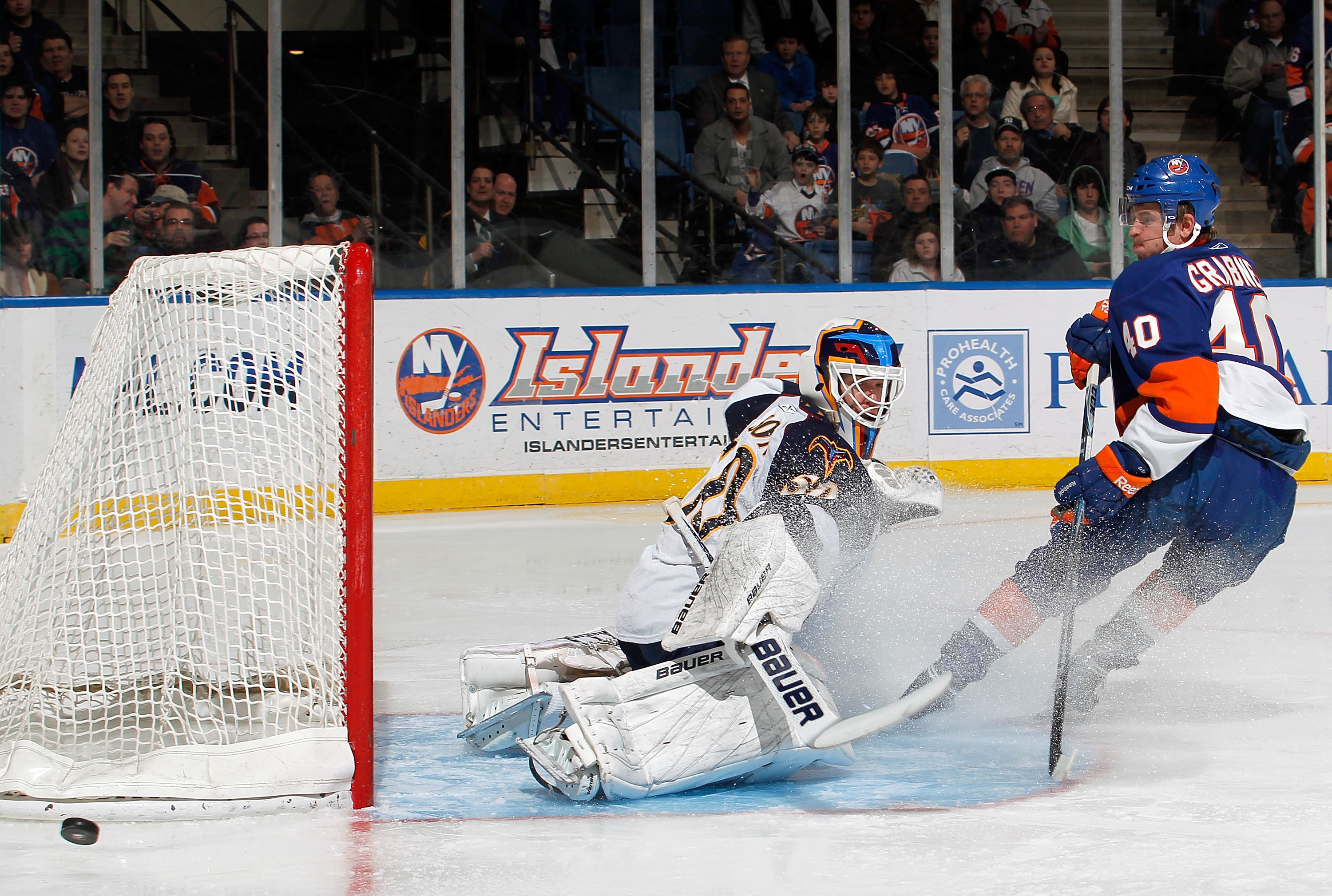 UNIONDALE, NY - MARCH 24:  Goalie Chris Mason #50 of the Atlanta Thrashers makes a save on this breakaway by Michael Grabner #40 of the New York Islanders during the second period of an NHL hockey game at the Nassau Coliseum on March 24, 2011 in Uniondale