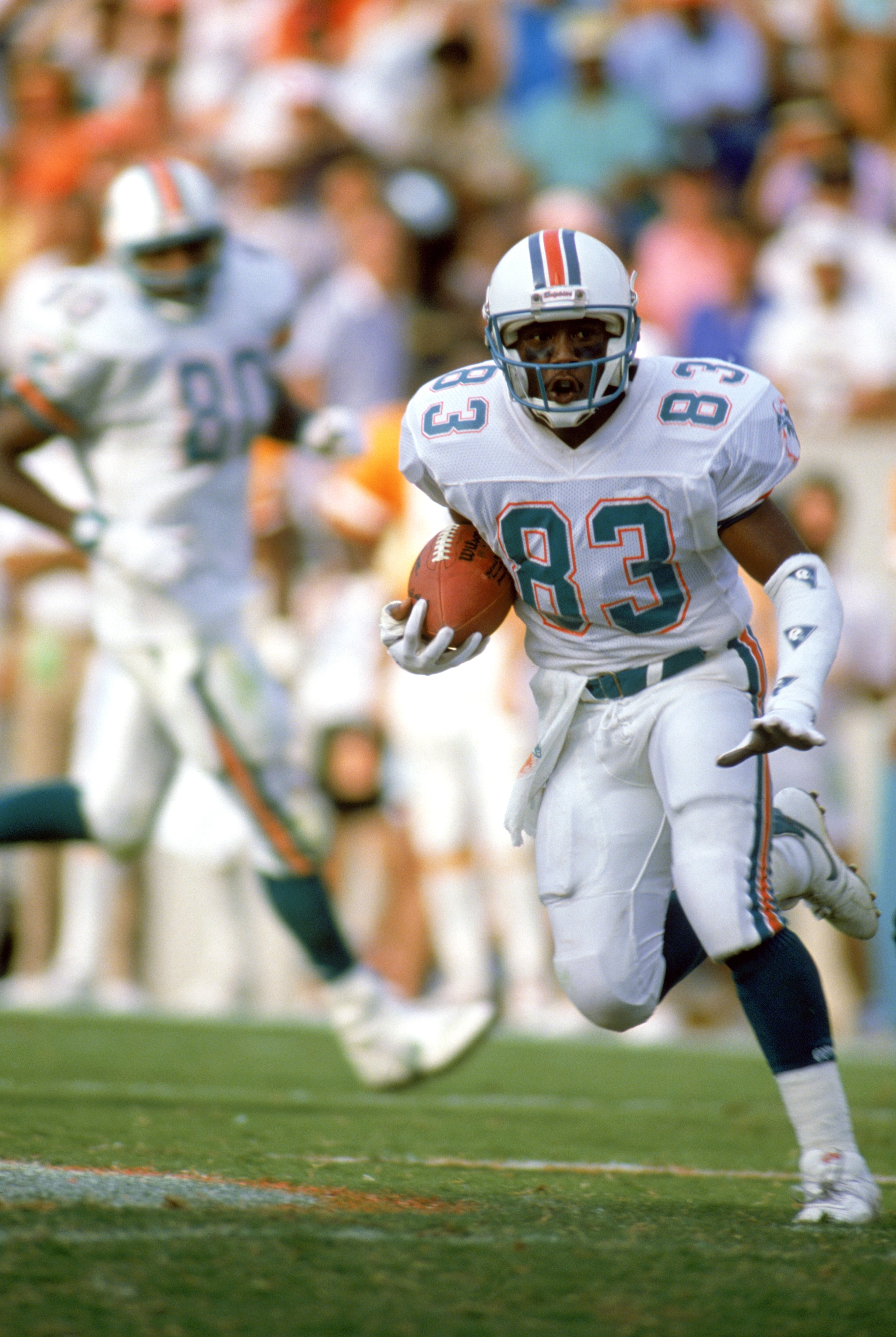 1988:  Wide receiver Mark Clayton #83 of the Miami Dolphins runs with the ball during a 1988 season game. (Photo by Allen Steele/Getty Images)