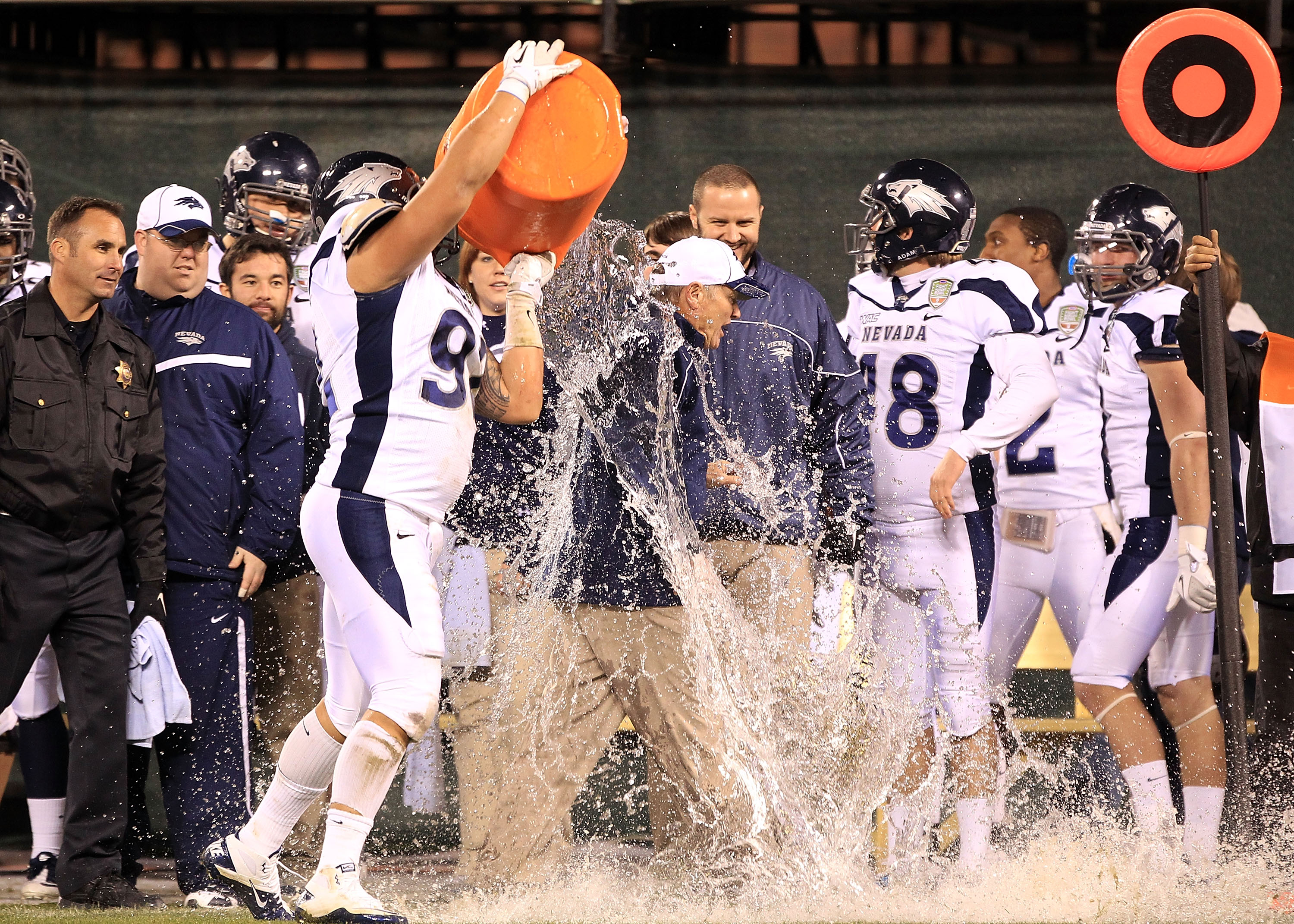 SAN FRANCISCO, CA - JANUARY 09:  Head coach Chris Ault of the Nevada Wolf Pack is covered in water by Mike Andrews #92  in the closing minute of their victory over Boston College in the Kraft Fight Hunger Bowl at AT&T Park on January 9, 2011 in San Franci