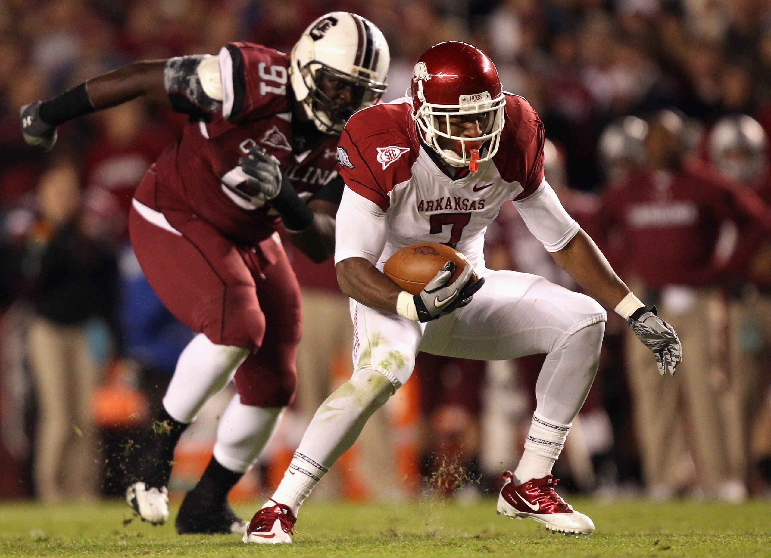 COLUMBIA, SC - NOVEMBER 06: Knile Davis #7 of the Arkansas Razorbacks runs with the ball as Ladi Ajiboye #91 of the South Carolina Gamecocks runs after him during their game at Williams-Brice Stadium on November 6, 2010 in Columbia, South Carolina. (Pho COLUMBIA, SC - NOVEMBER 06: Knile Davis #7 of the Arkansas Razorbacks runs with the ball as Ladi Ajiboye #91 of the South Carolina Gamecocks runs after him during their game at Williams-Brice Stadium on November 6, 2010 in Columbia, South Carolina. (Pho