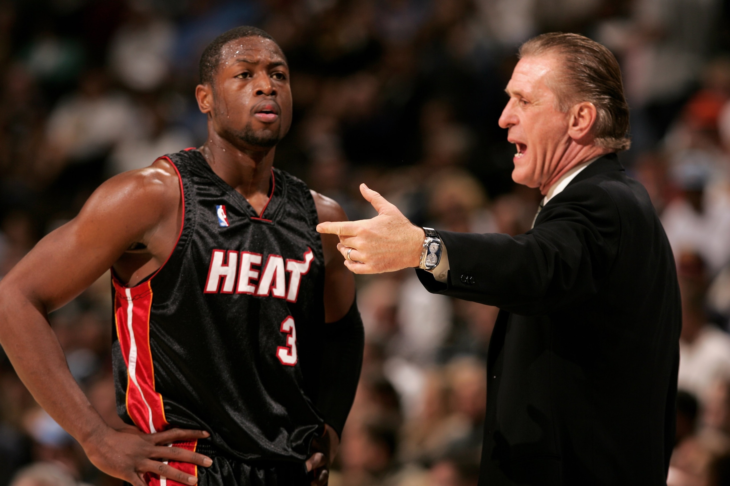DENVER - DECEMBER 08:  Head coach Pat Riley talks with Dwyane Wade #3 of the Miami Heat as they face the Denver Nuggets on December 8, 2006 at the Pepsi Center in Denver, Colorado. NOTE TO USER: User expressly acknowledges and agrees that, by downloading