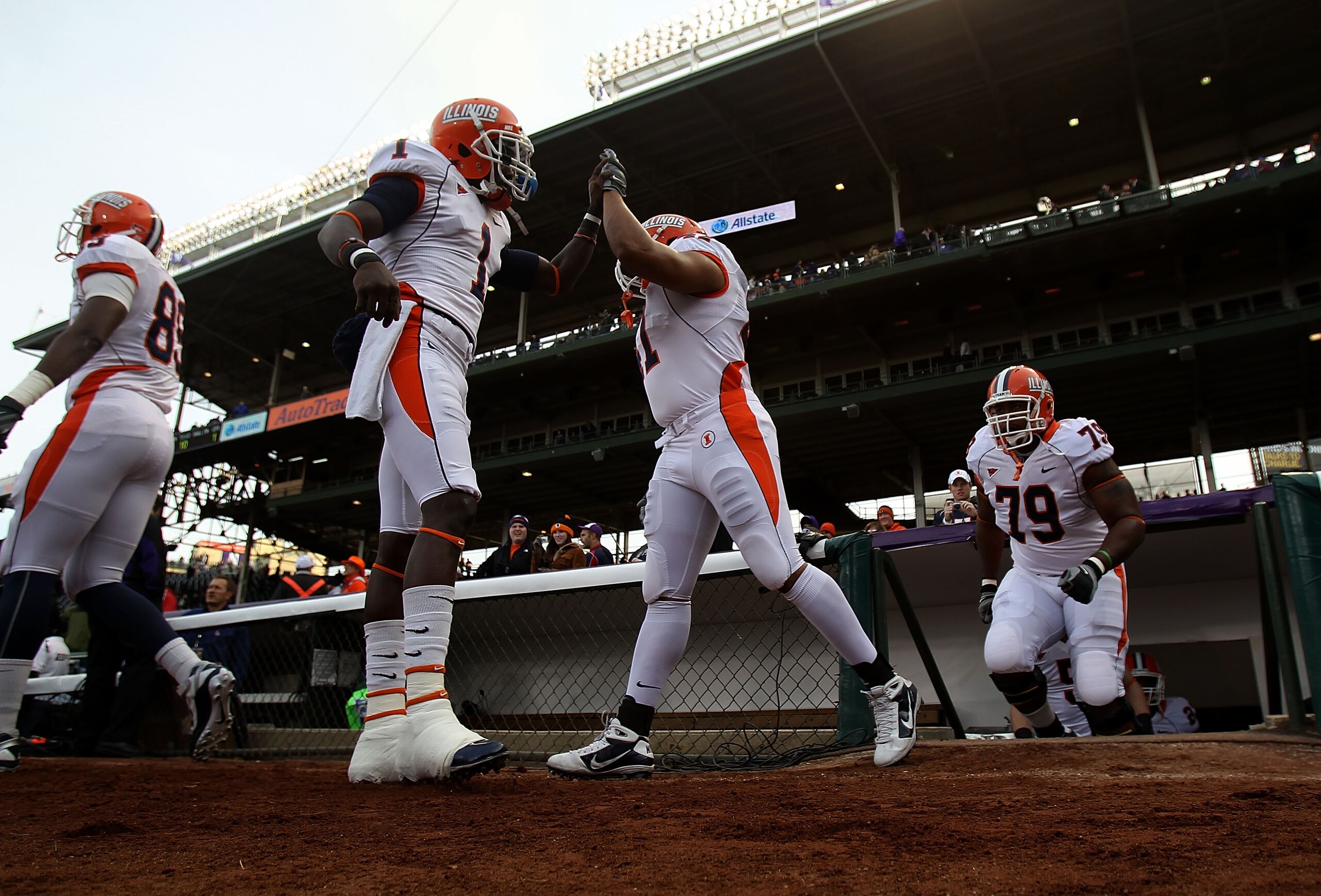 CHICAGO - NOVEMBER 20: Members of the Illinois Fighting Illini enter the field for warm-ups before a game against the Northwestern Wildcats played at Wrigley Field on November 20, 2010 in Chicago, Illinois. (Photo by Jonathan Daniel/Getty Images) CHICAGO - NOVEMBER 20: Members of the Illinois Fighting Illini enter the field for warm-ups before a game against the Northwestern Wildcats played at Wrigley Field on November 20, 2010 in Chicago, Illinois. (Photo by Jonathan Daniel/Getty Images)