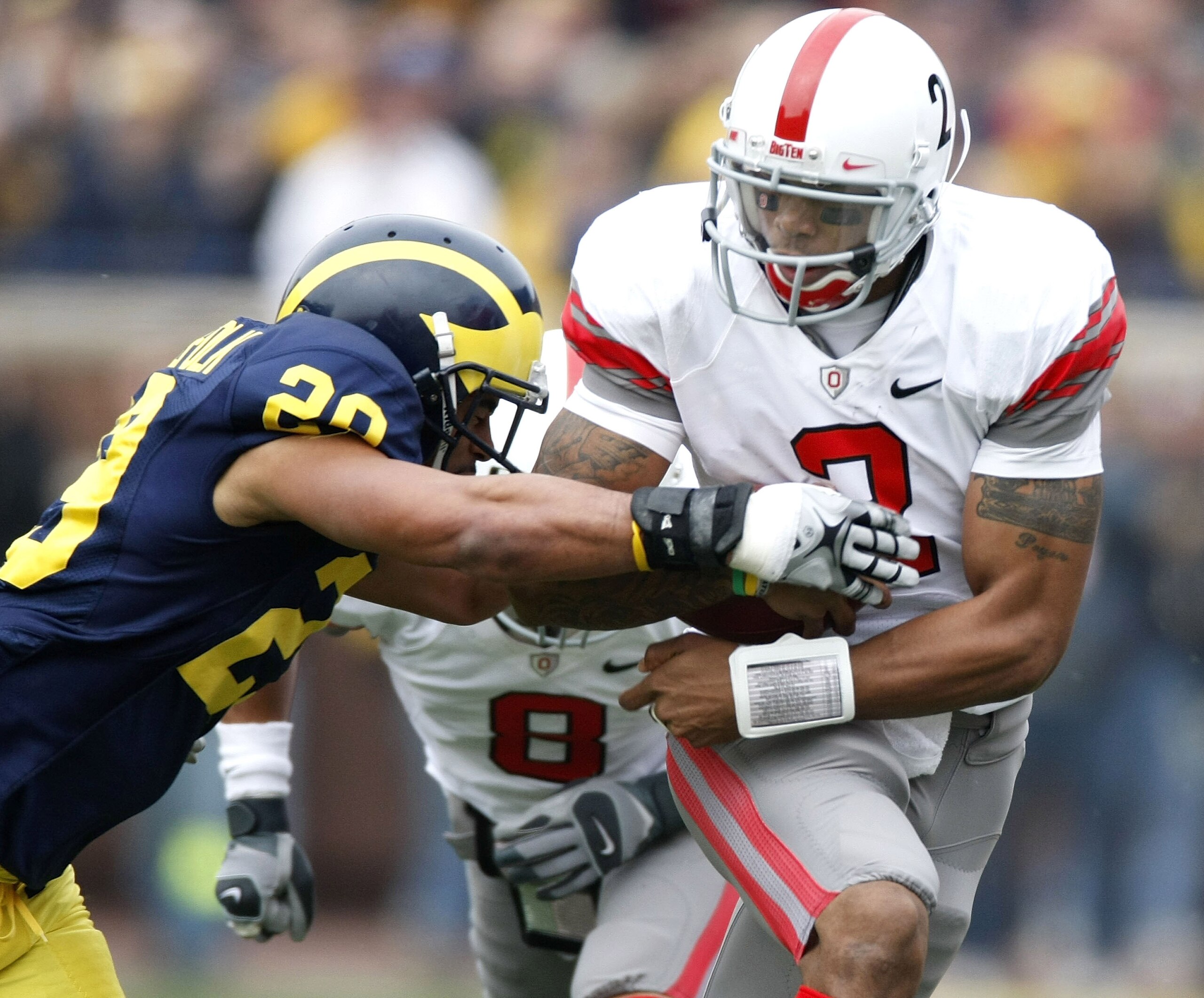 ANN ARBOR, MI - NOVEMBER 21:  Terrelle Pryor #2 of the Ohio State Buckeyes tries to get around Troy Woolfolk #29 of the Michigan Wolverines on November 21, 2009 at Michigan Stadium in Ann Arbor, Michigan.  (Photo by Gregory Shamus/Getty Images)