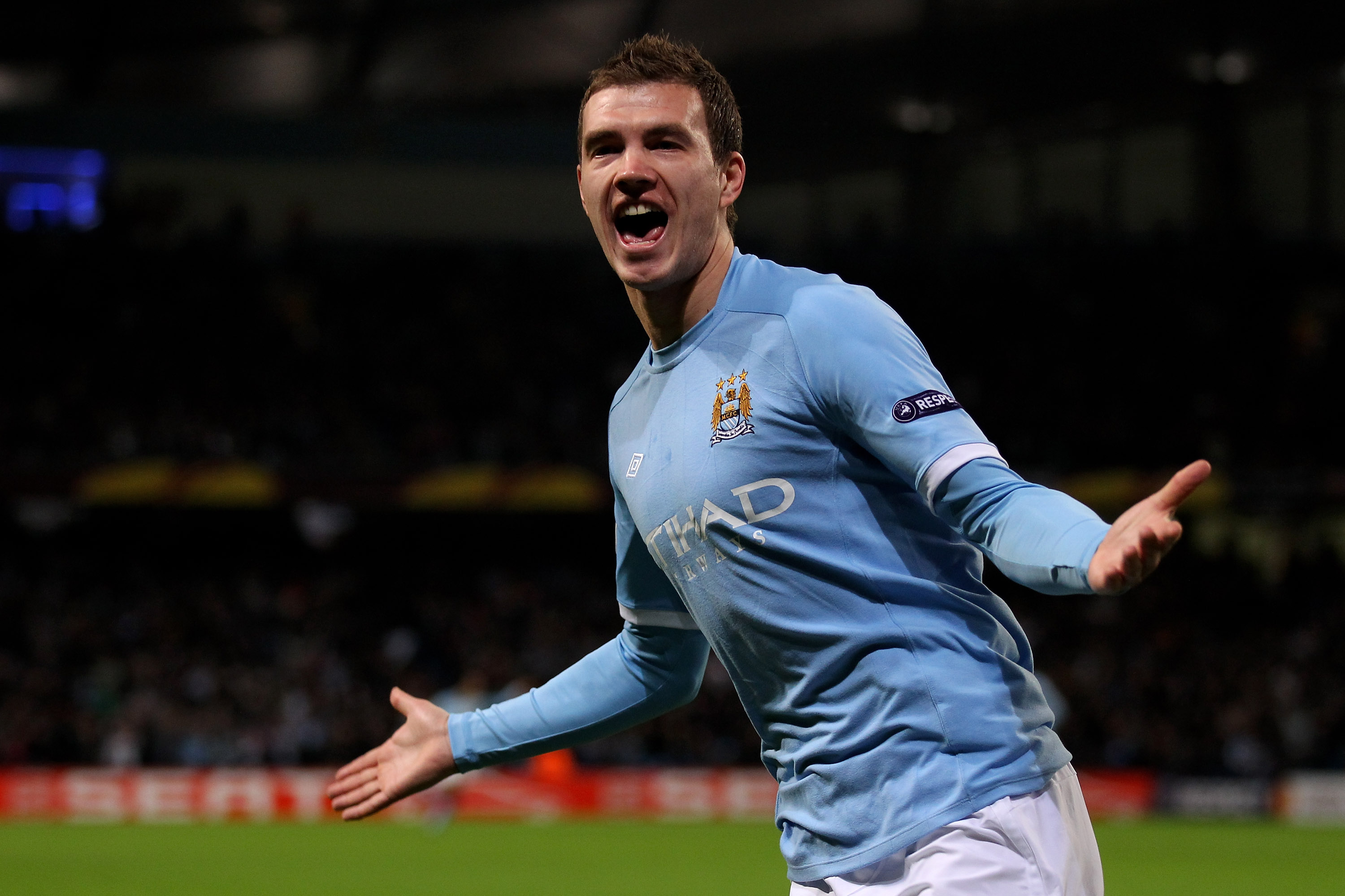 MANCHESTER, ENGLAND - FEBRUARY 24:  Edin Dzeko of City celebrates as he scores the opening goal during the UEFA Europa League round of 32 second leg match between Manchester City and Aris Saloniki at City of Manchester Stadium on February 24, 2011 in Manc