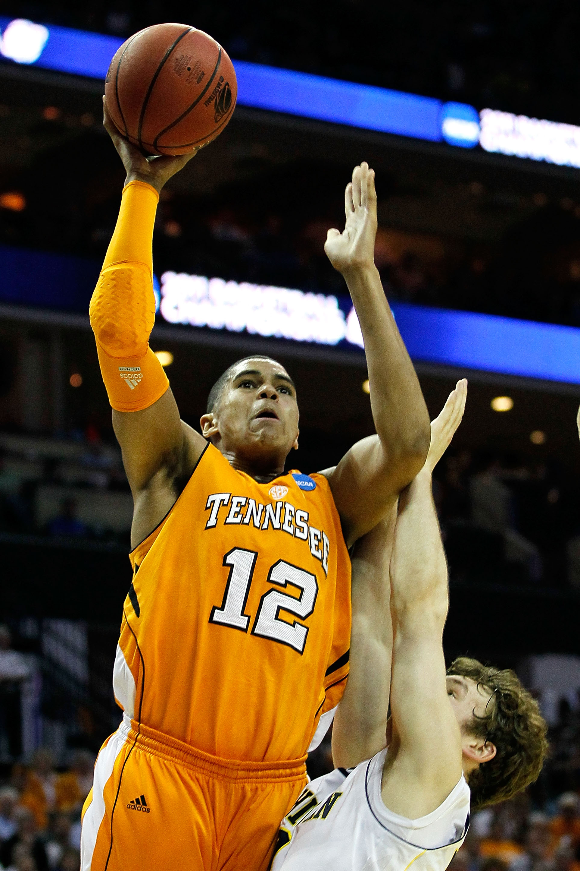 CHARLOTTE, NC - MARCH 18:  Tobias Harris #12 of the Tennessee Volunteers shoots over Zack Novak #0 of the Michigan Wolverines in the first half during the second round of the 2011 NCAA men's basketball tournament at Time Warner Cable Arena on March 18, 20