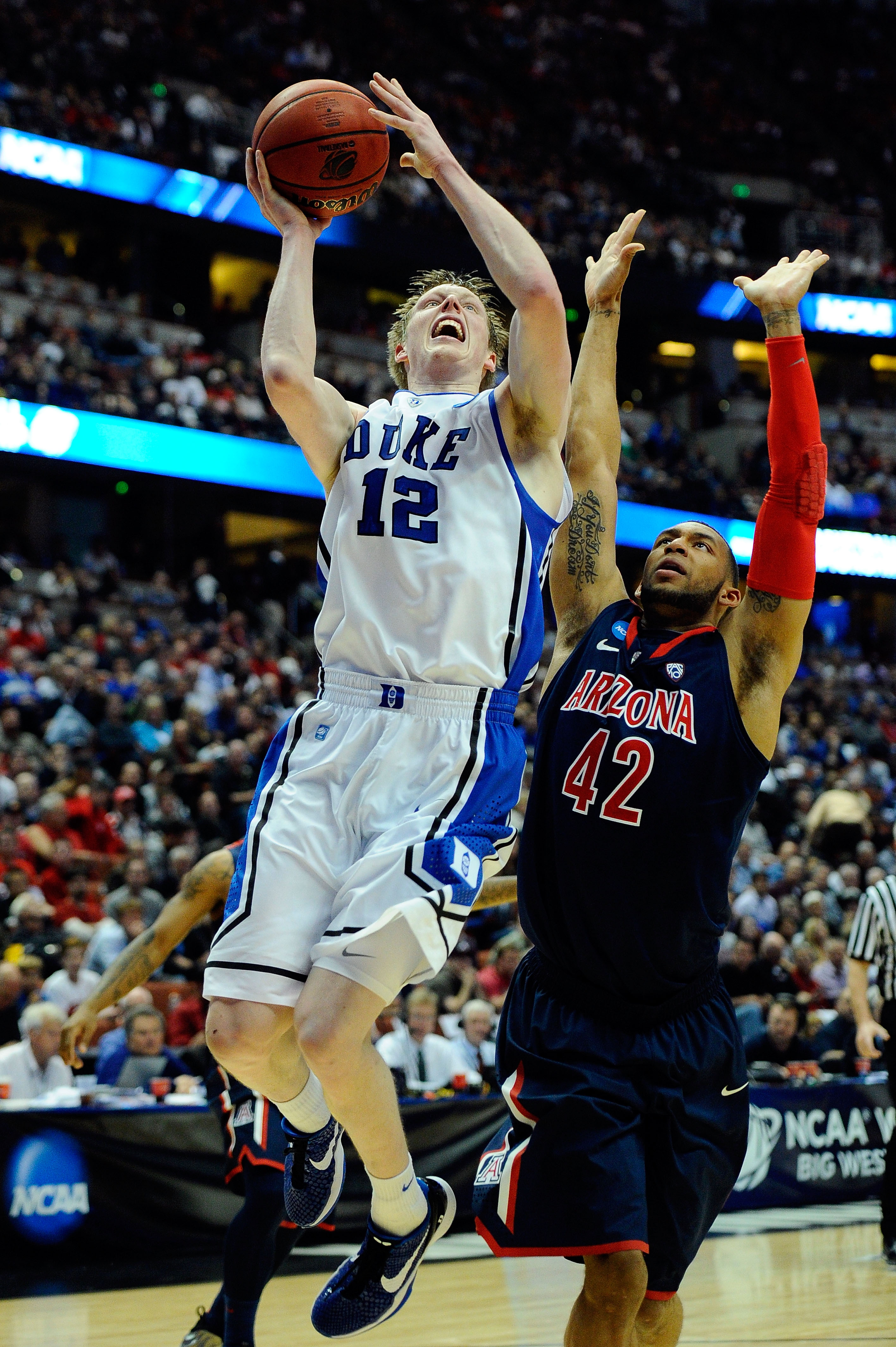 ANAHEIM, CA - MARCH 24:  Kyle Singler #12 of the Duke Blue Devils goes to the basket against Jamelle Horne #42 of the Arizona Wildcats during the west regional semifinal of the 2011 NCAA men's basketball tournament at the Honda Center on March 24, 2011 in