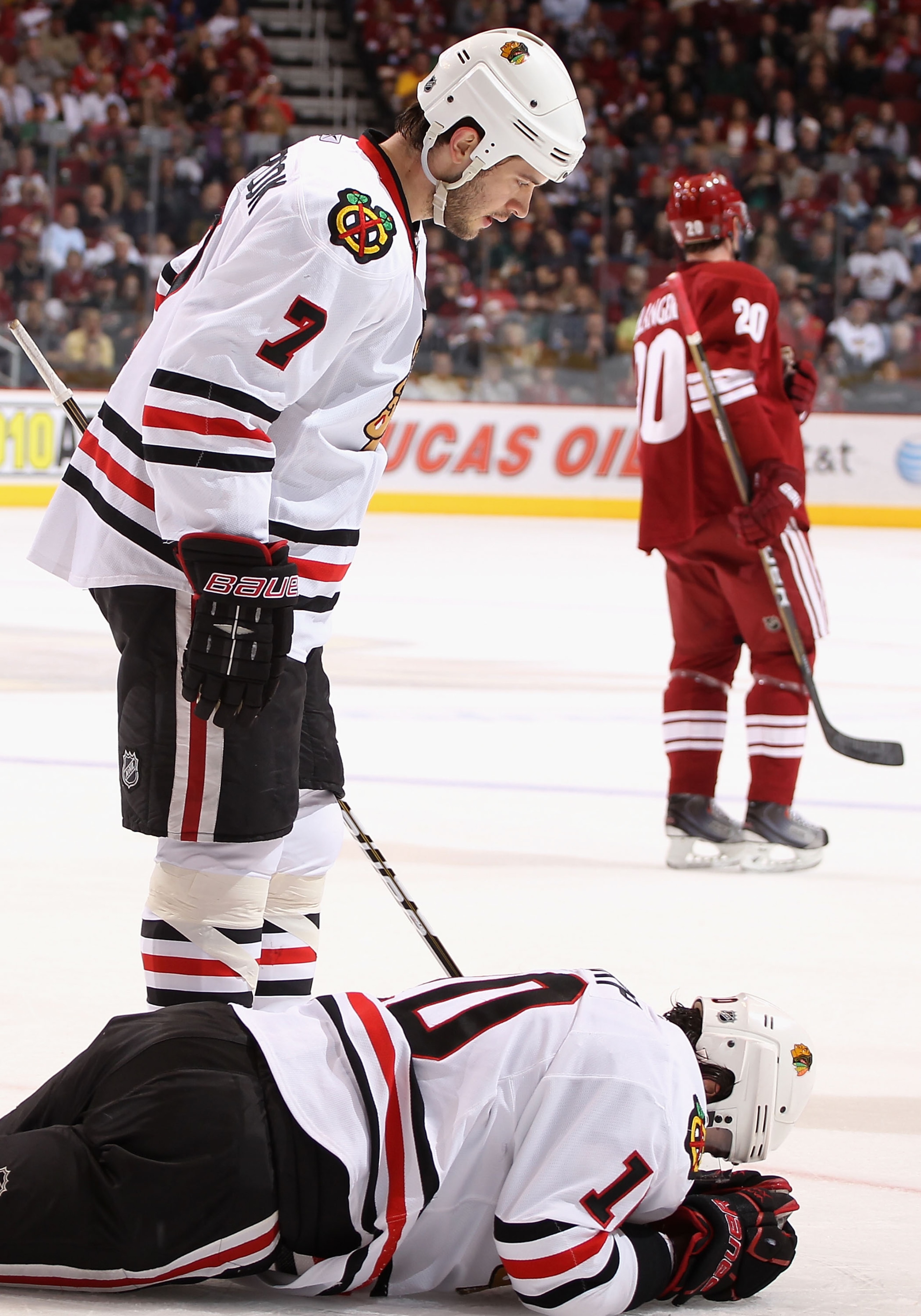 GLENDALE, AZ - MARCH 20: Patrick Sharp #10 of the Chicago Blackhawks lays on the ice after an injury as Brent Seabrook #7 looks down during the first period of the NHL game against the Phoenix Coyotes at Jobing.com Arena on March 20, 2011 in Glendale, Ar GLENDALE, AZ - MARCH 20: Patrick Sharp #10 of the Chicago Blackhawks lays on the ice after an injury as Brent Seabrook #7 looks down during the first period of the NHL game against the Phoenix Coyotes at Jobing.com Arena on March 20, 2011 in Glendale, Ar