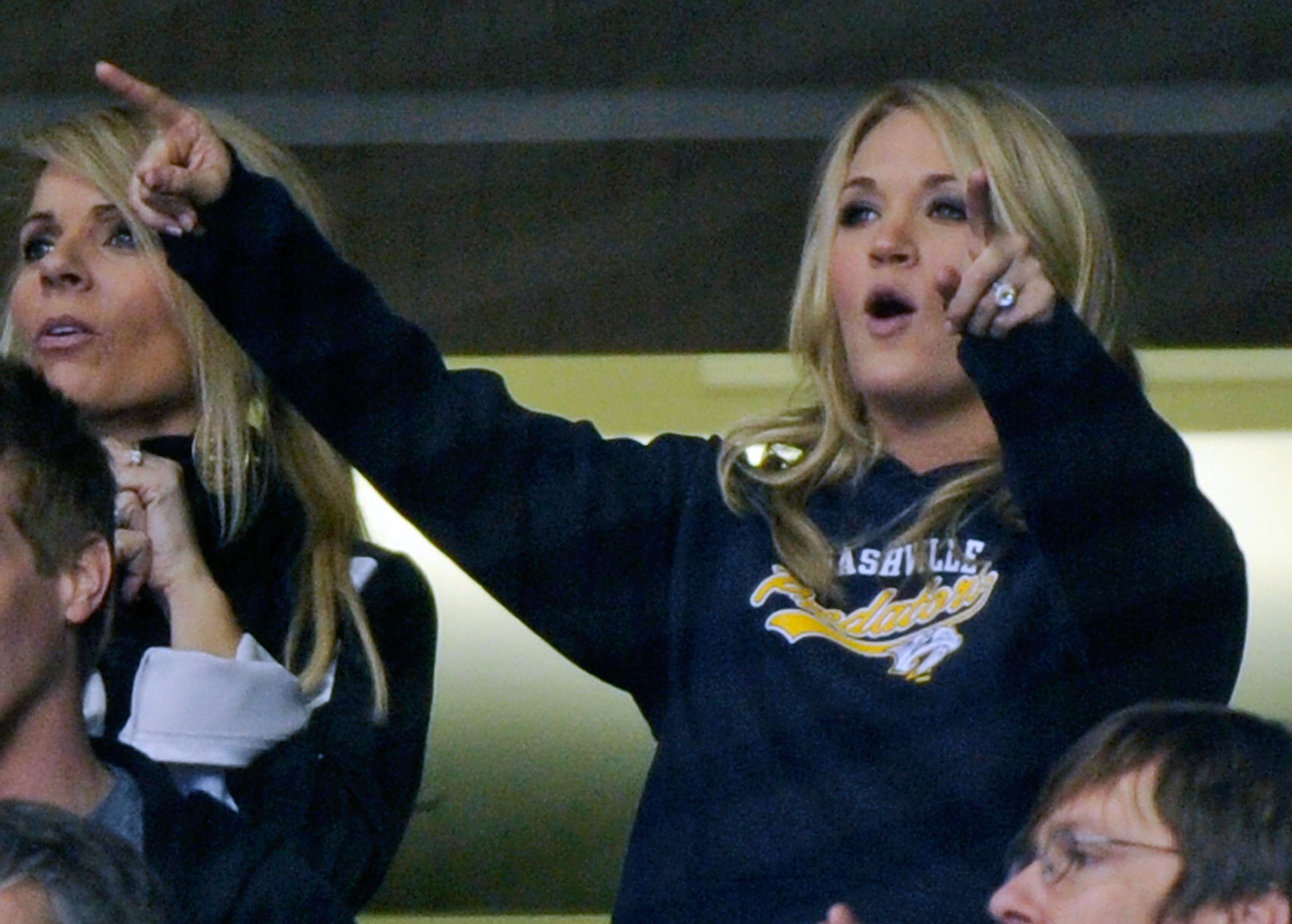 NASHVILLE, TN - FEBRUARY 17:  Country music singer Carrie Underwood celebrates after a goal by the Nashville Predators against the Vancouver Canucks on February 17, 2011 at the Bridgestone Arena in Nashville, Tennessee.  (Photo by Frederick Breedon/Getty
