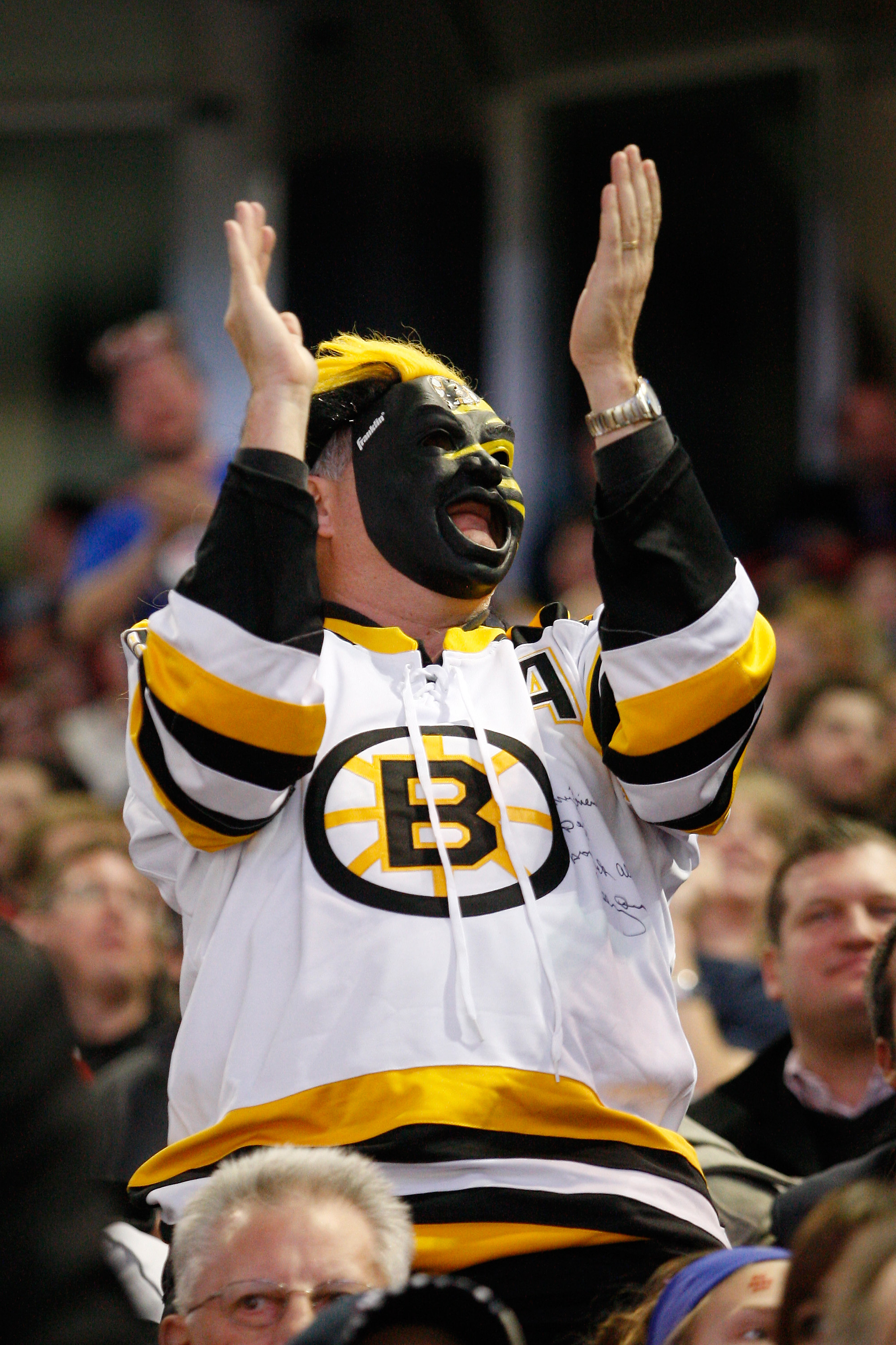 MONTREAL, CANADA - JANUARY 8:  A Boston Bruins fan celebrates the Bruins first goal of the game during the NHL game against the Montreal Canadiens at the Bell Centre on January 8, 2011 in Montreal, Quebec, Canada.  (Photo by Richard Wolowicz/Getty Images)