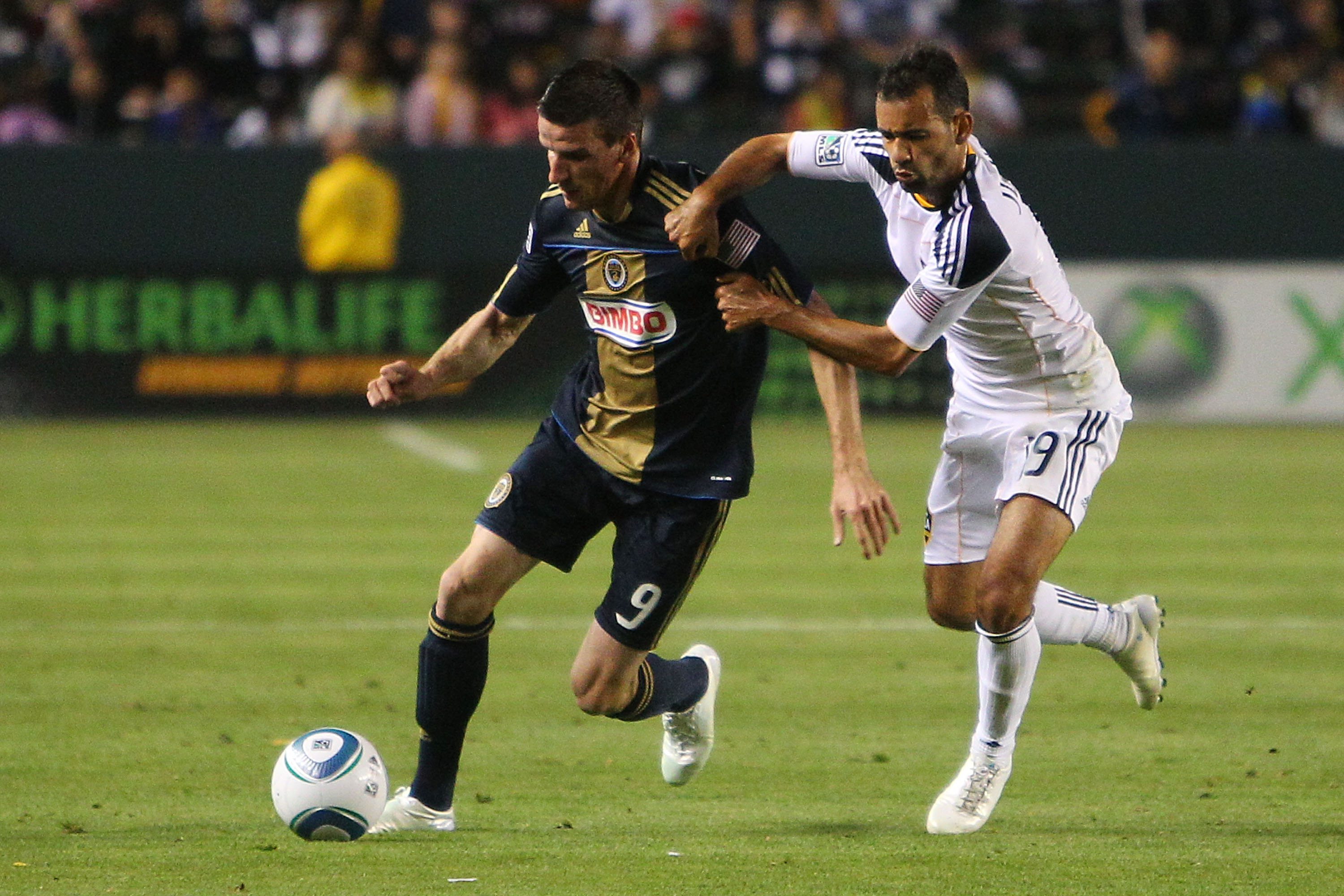 CARSON, CA - APRIL 02:  Sebastien Le Toux #9 of the Philadelphia Union defends against Juninho #19 of the Los Angeles Galaxy during the match at The Home Depot Center on April 2, 2011 in Carson, California.  (Photo by Joe Scarnici/Getty Images)