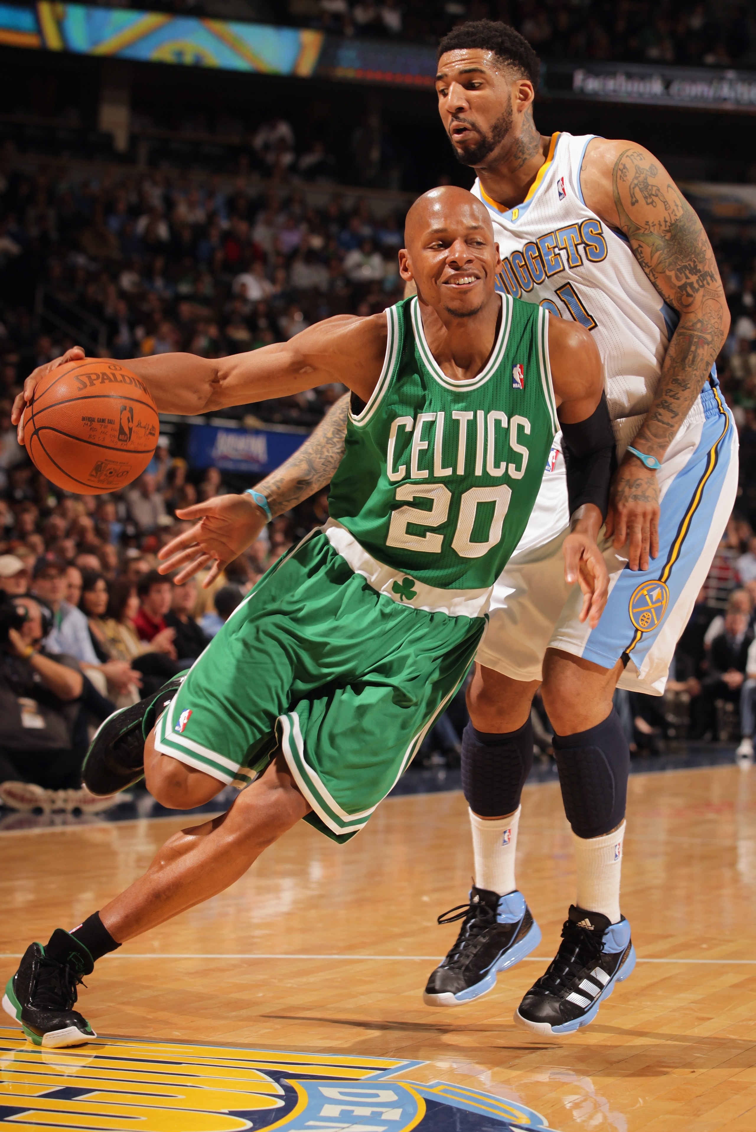 DENVER, CO - FEBRUARY 24:  Ray Allen #20 of the Boston Celtics drives around Wilson Chandler #21 of the Denver Nuggets during NBA action at the Pepsi Center on February 24, 2011 in Denver, Colorado. NOTE TO USER: User expressly acknowledges and agrees tha