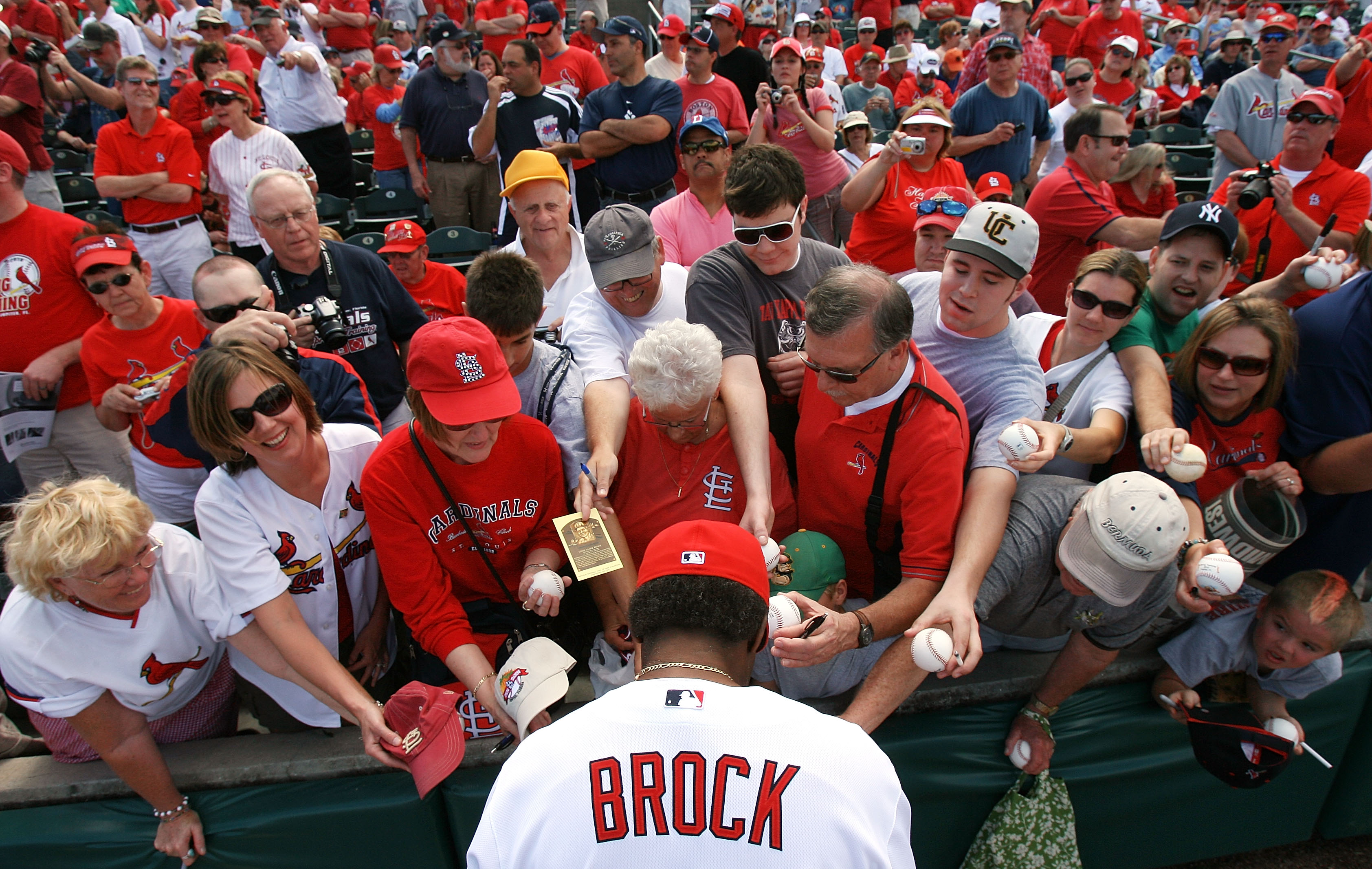 JUPITER, FL - MARCH 10:  Hall-of-Famer Lou Brock #20 of the St Louis Cardinals signs autographs for fans before taking on the Washington Nationals at Roger Dean Stadium on March 10, 2010 in Jupiter, Florida.  (Photo by Doug Benc/Getty Images)