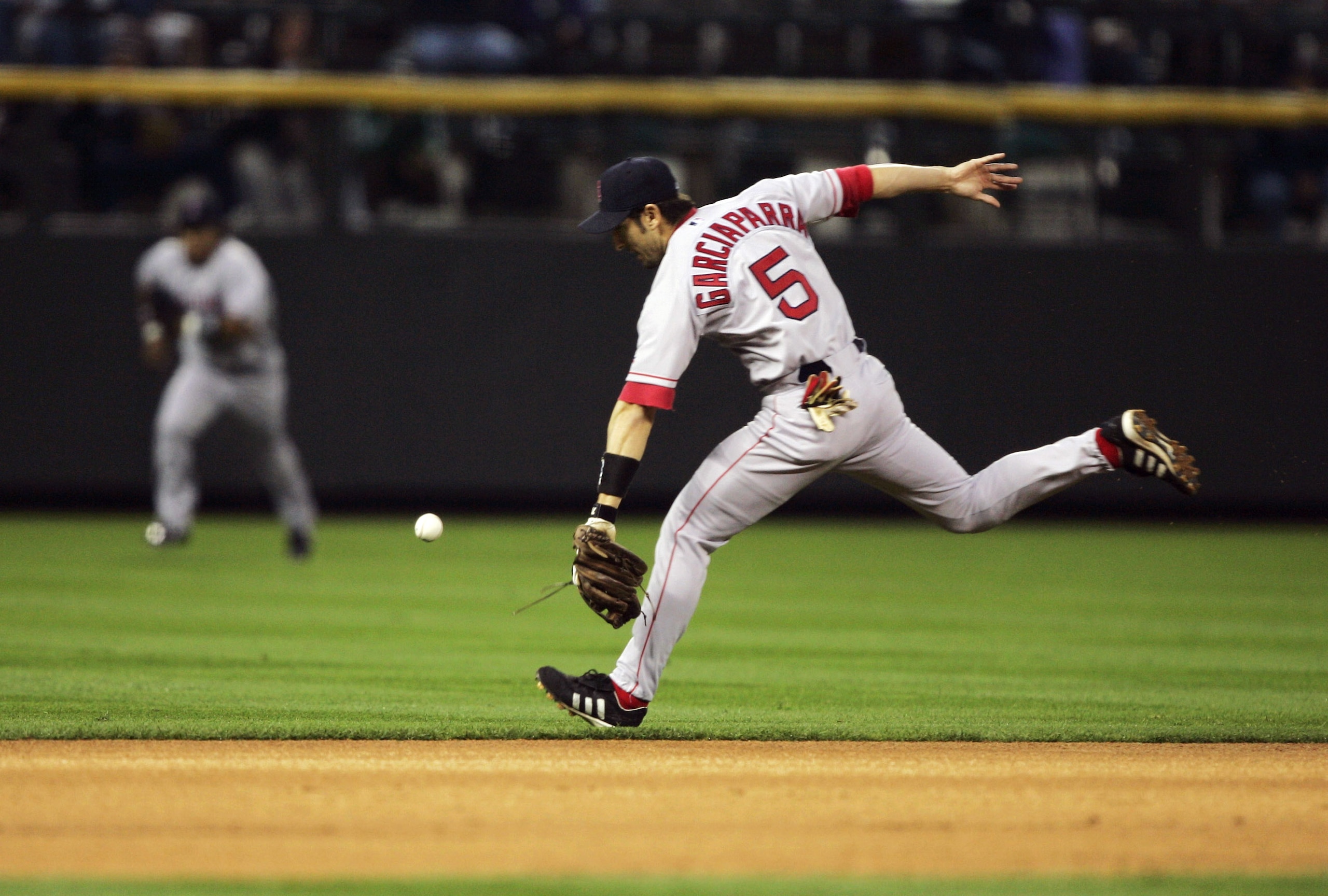 DENVER - JUNE 16:  Shortstop Nomar Garciaparra #5 of the Boston Red Sox can't get to a single by Royce Clayton of the Colorado Rockies in the first inning June 16, 2004 at Coors Field in Denver, Colorado.  (Photo by Brian Bahr/Getty Images)