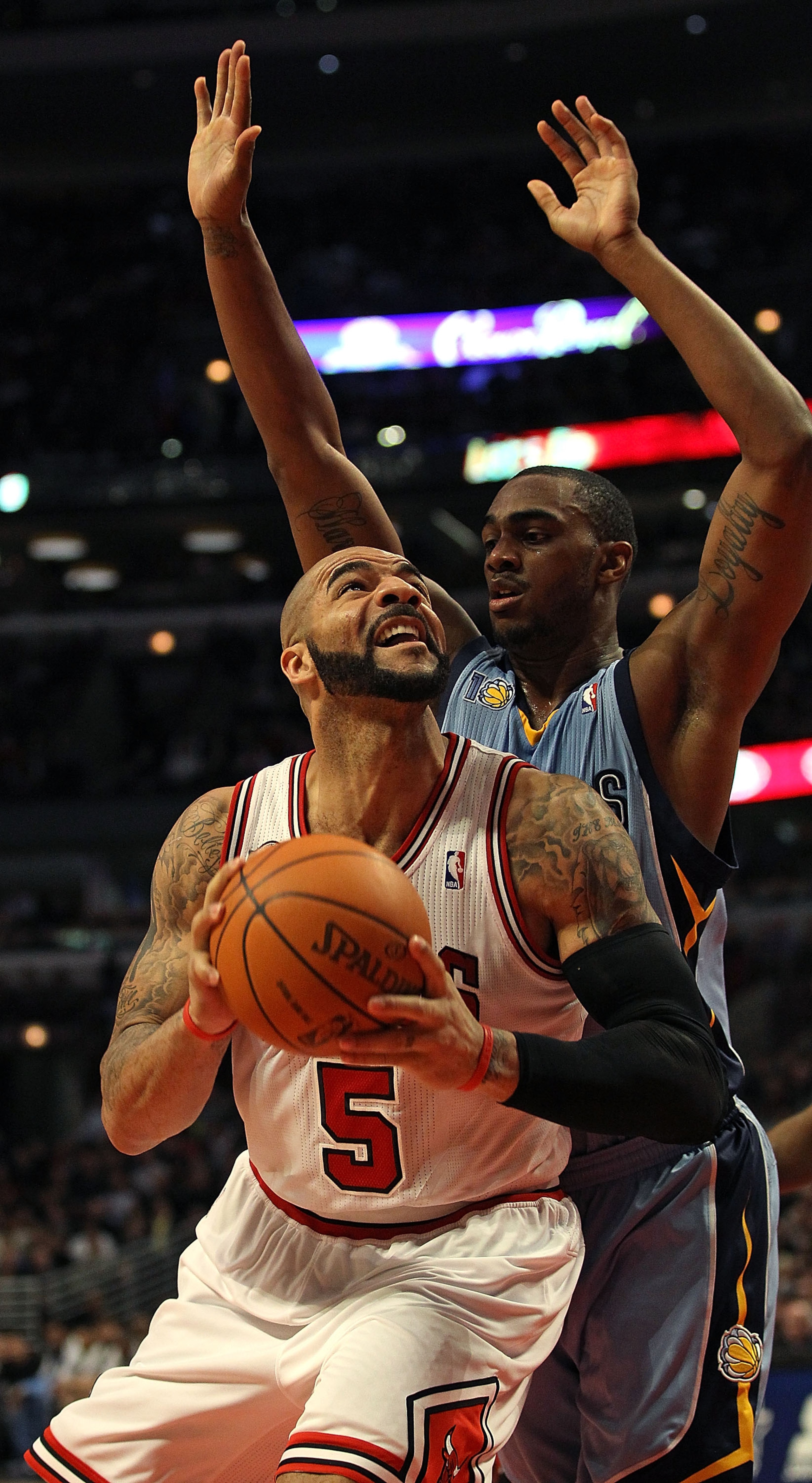CHICAGO, IL - MARCH 25: Carlos Boozer #5 of the Chicago Bulls waits to put up a shot against Darnell Arthur #00 of the Memphis Grizzlies at the United Center on March 25, 2011 in Chicago, Illinois. The Bulls defeated the Grizzlies 99-96. NOTE TO USER: Use