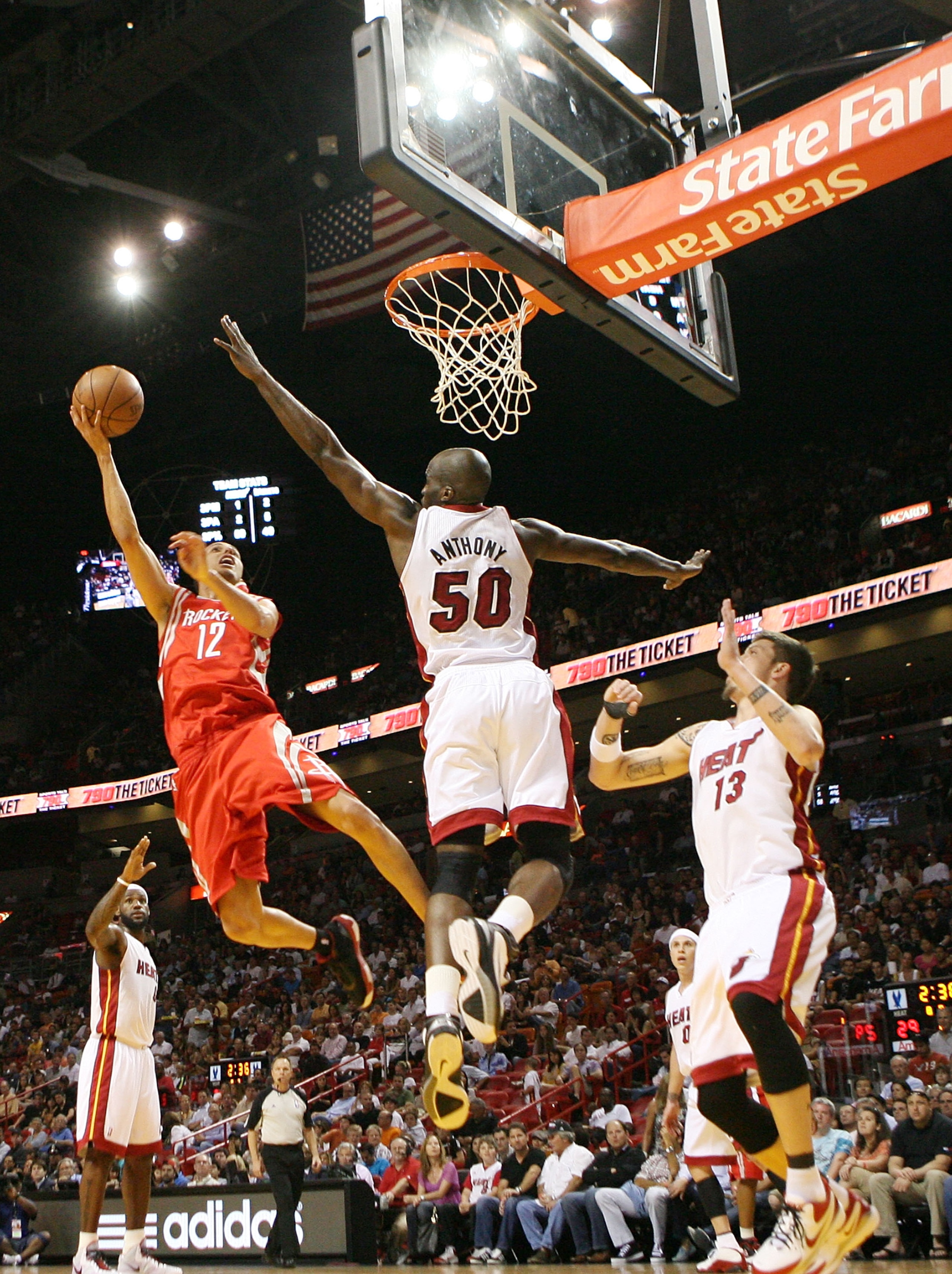 MIAMI, FL - MARCH 27:  Forward Mike Miller #13 (R) and Joel Anthony #50 of the Miami Heat defend  against gurad Kevin Martin #12 of the Houston Rockets  at American Airlines Arena on March 27, 2011 in Miami, Florida. NOTE TO USER: User expressly acknowled