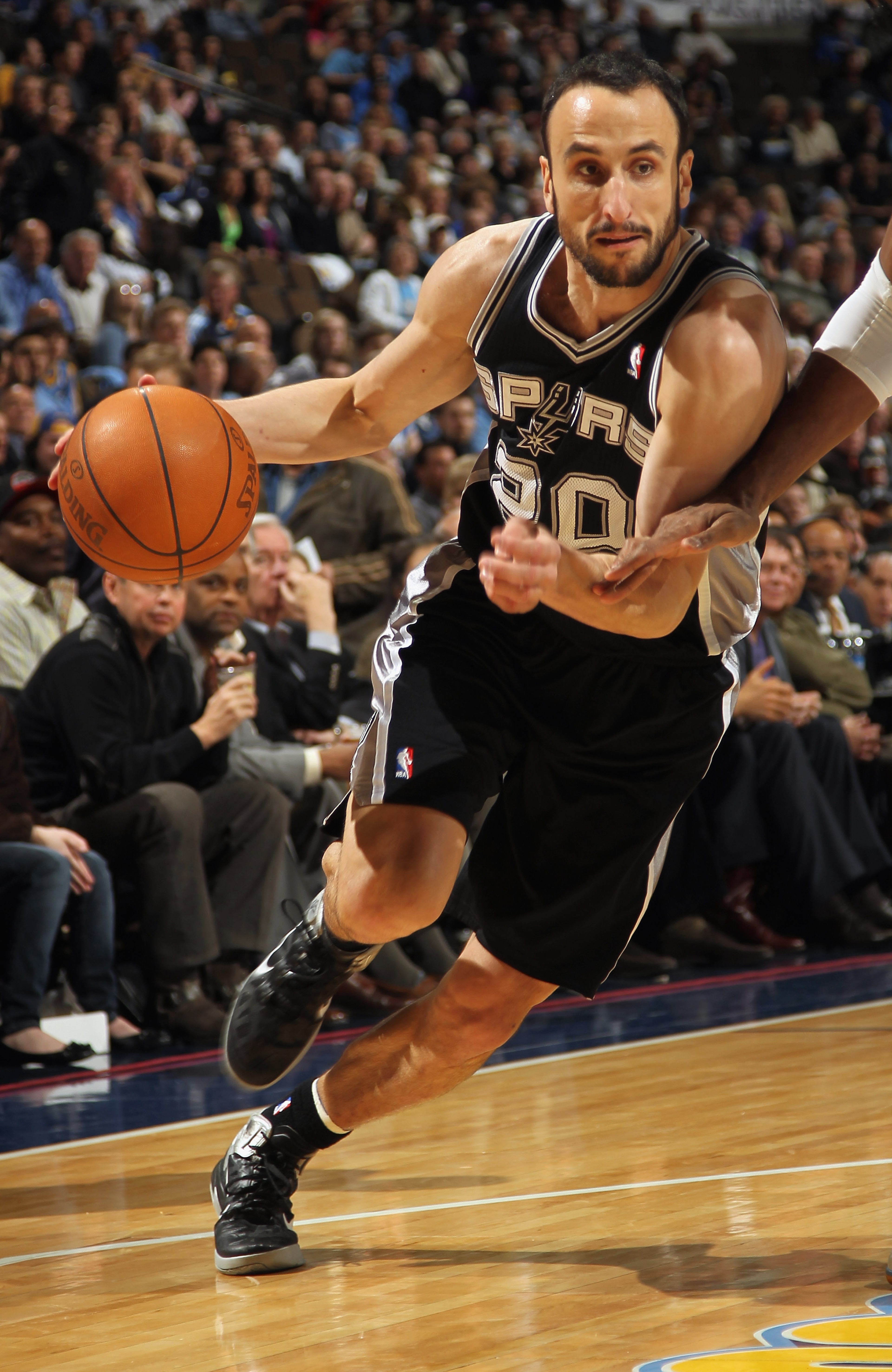 DENVER, CO - MARCH 23: Manu Ginobili #20 of the San Antonio Spurs drives to the basket against the Denver Nuggets at the Pepsi Center on March 23, 2011 in Denver, Colorado. The Nuggets defeated the Spurs 115-112. NOTE TO USER: User expressly acknowledges DENVER, CO - MARCH 23: Manu Ginobili #20 of the San Antonio Spurs drives to the basket against the Denver Nuggets at the Pepsi Center on March 23, 2011 in Denver, Colorado. The Nuggets defeated the Spurs 115-112. NOTE TO USER: User expressly acknowledges